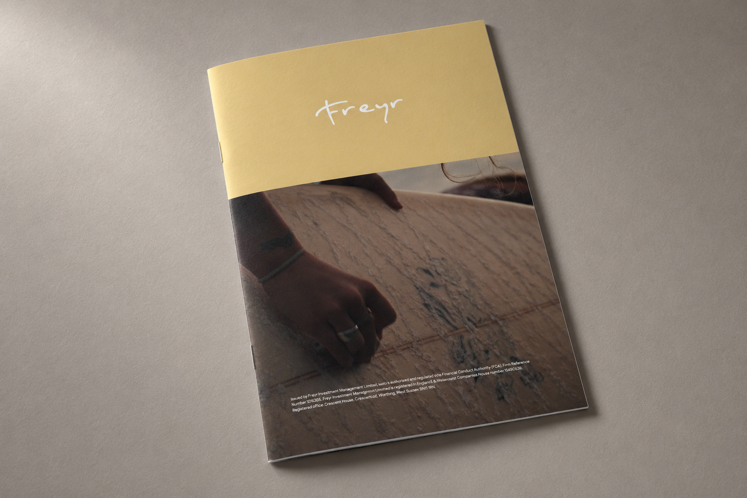 Frey property investment brochure featuring a close-up photo of hands touching textured wood