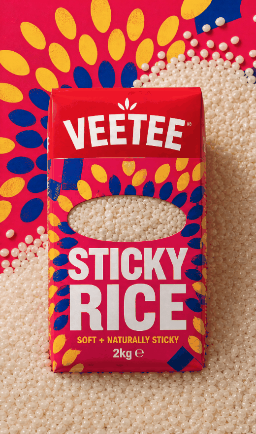 Veetee Sticky Rice 2kg package surrounded by uncooked sticky rice grains