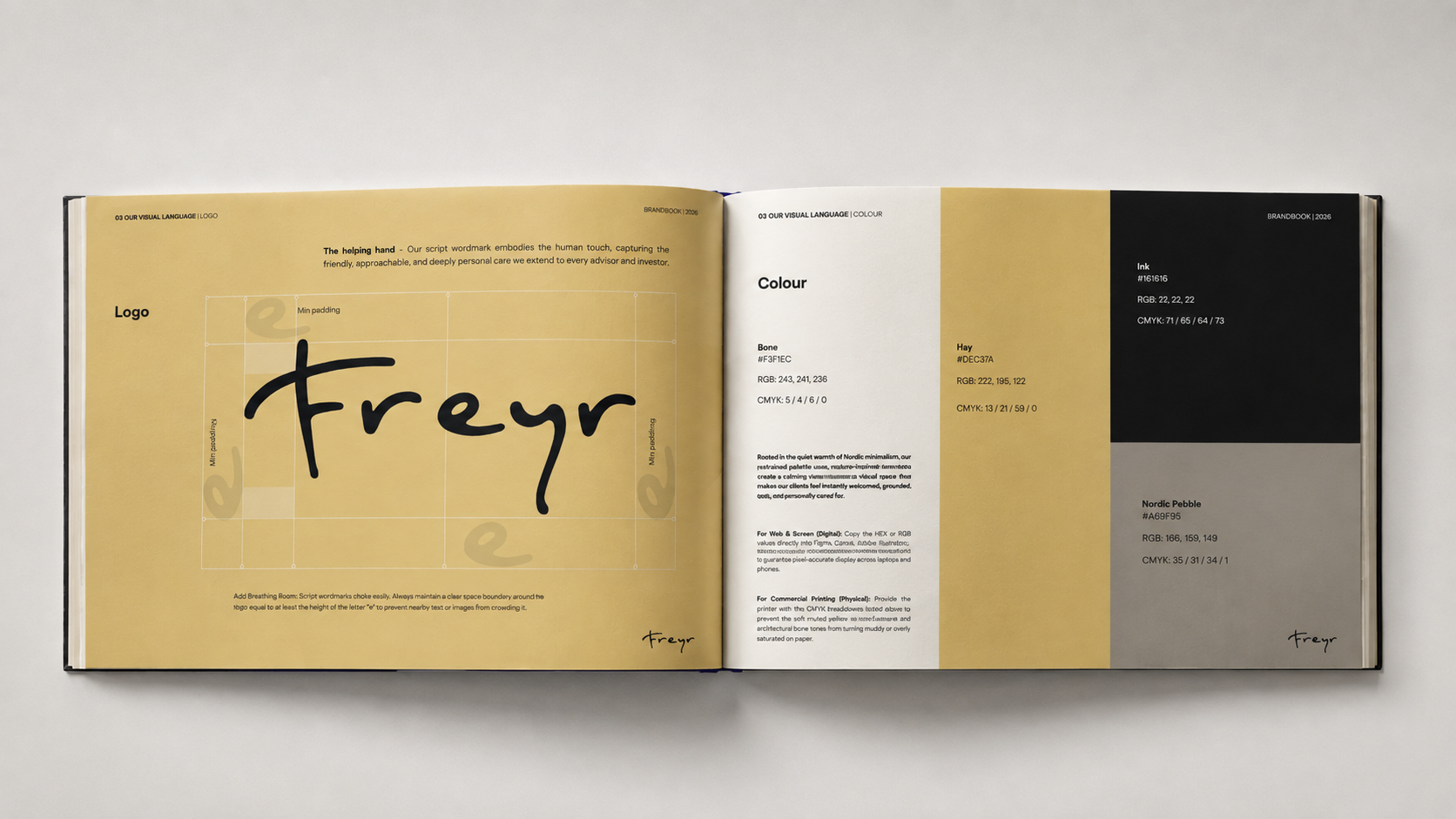 Open brand guidelines book showing Freyr logo usage and color palette with ink black, hay yellow, bone white, and Nordic pebble gray swatches.
