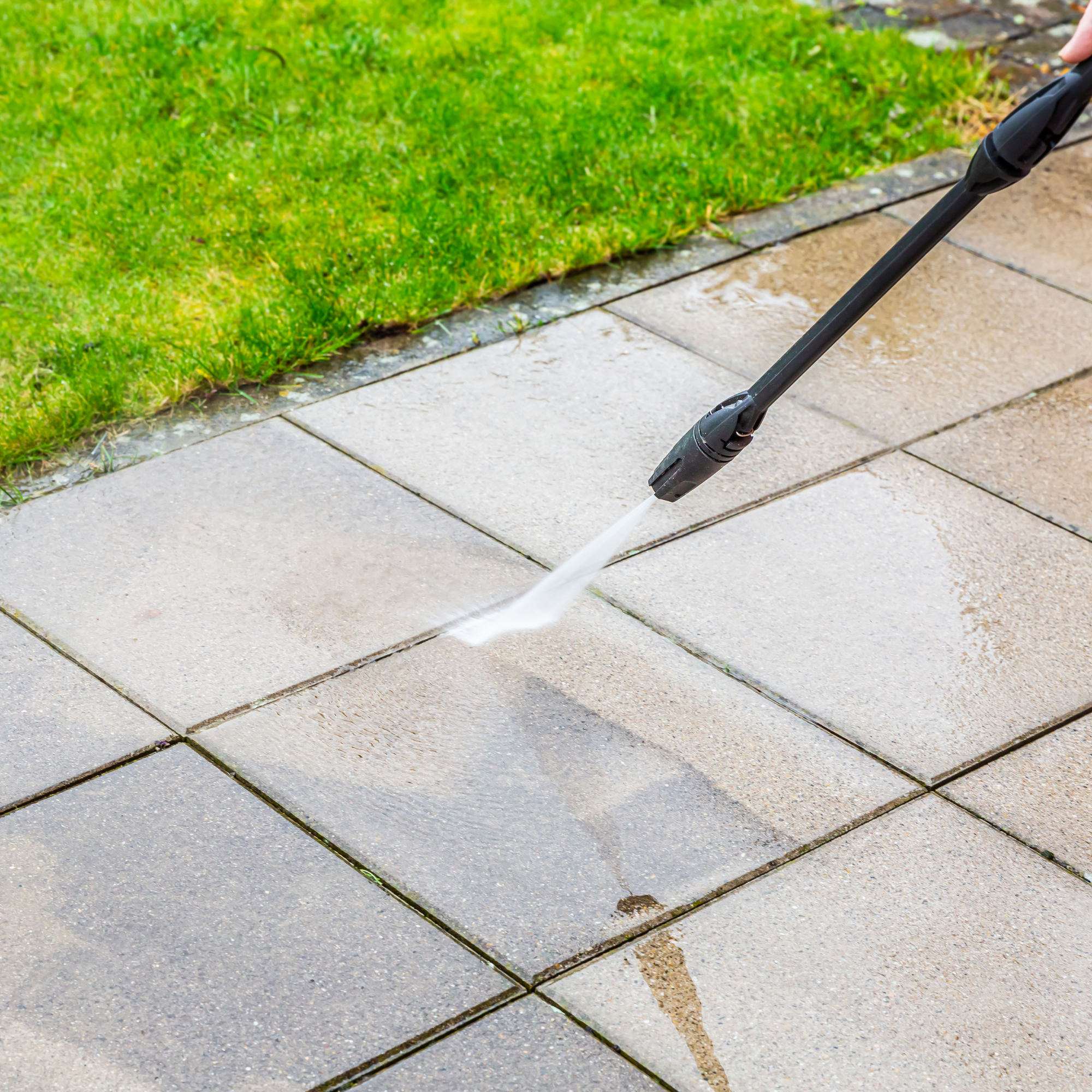 Patio being cleaned with a jet washer