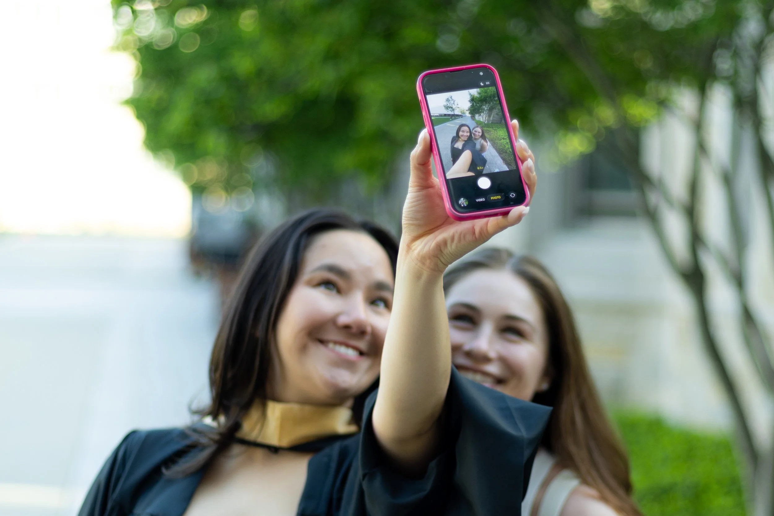 Graduate taking a selfie with friend