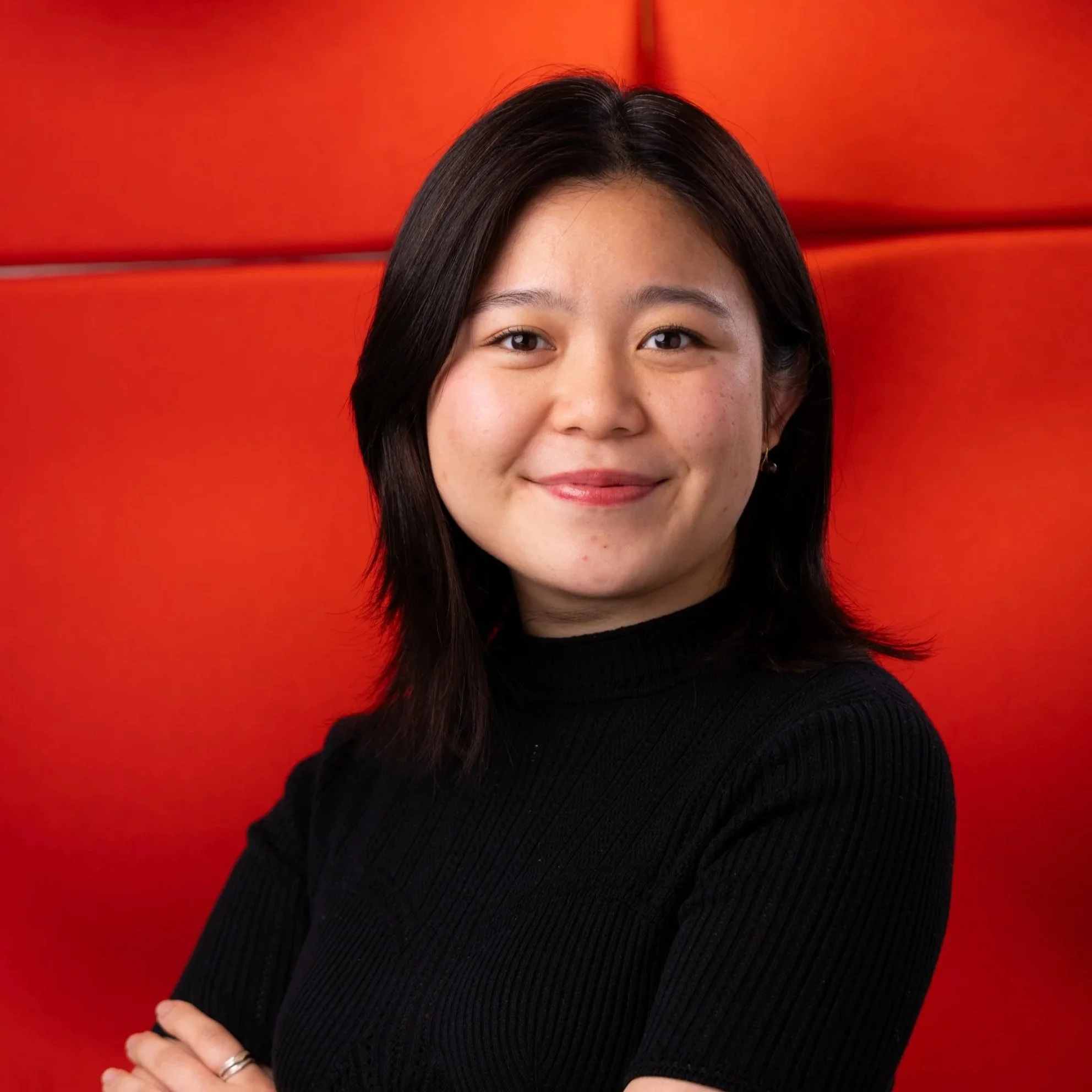 An asian woman posing for a high quality corporate headshot