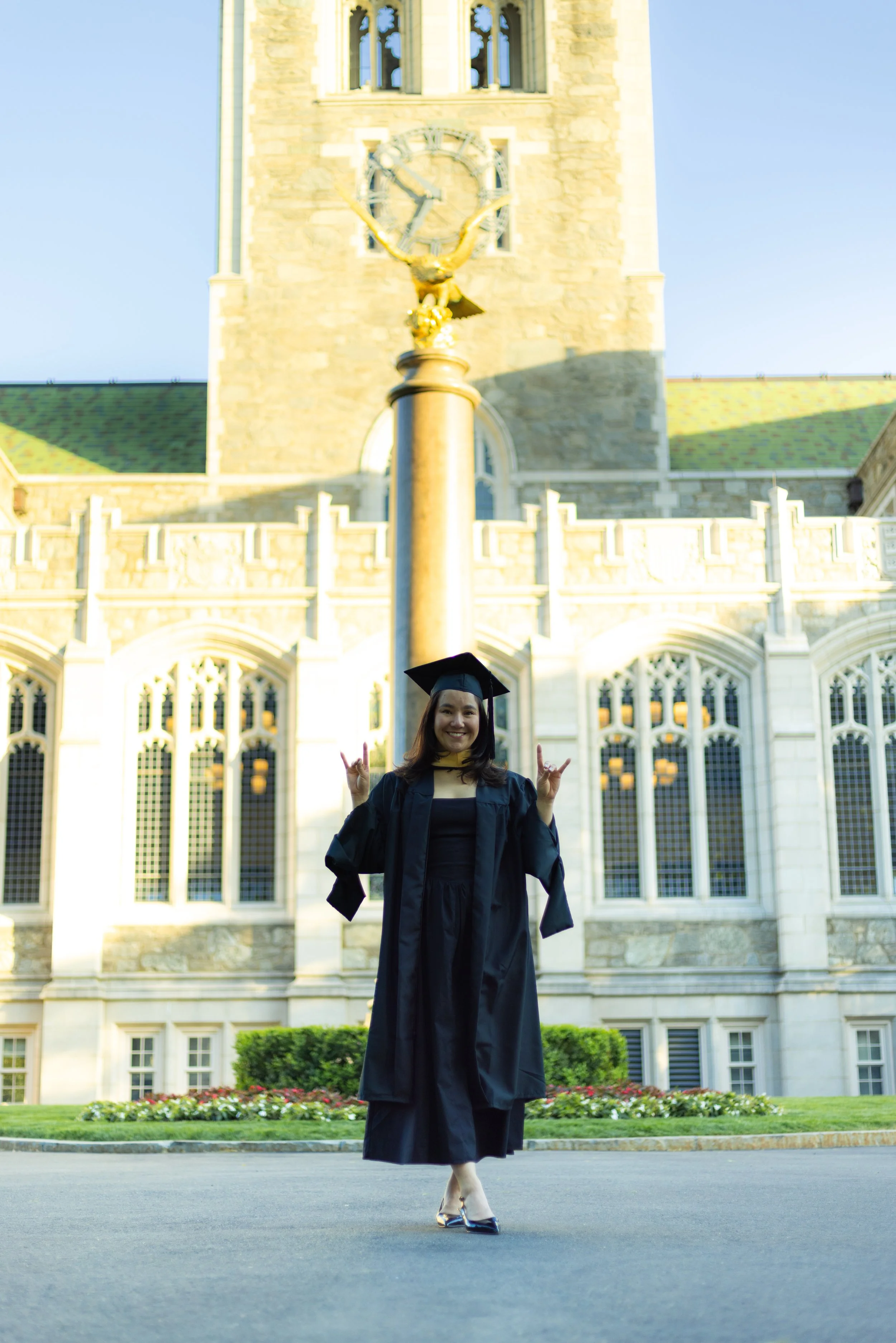 Boston College graduate posing in front of boston college building