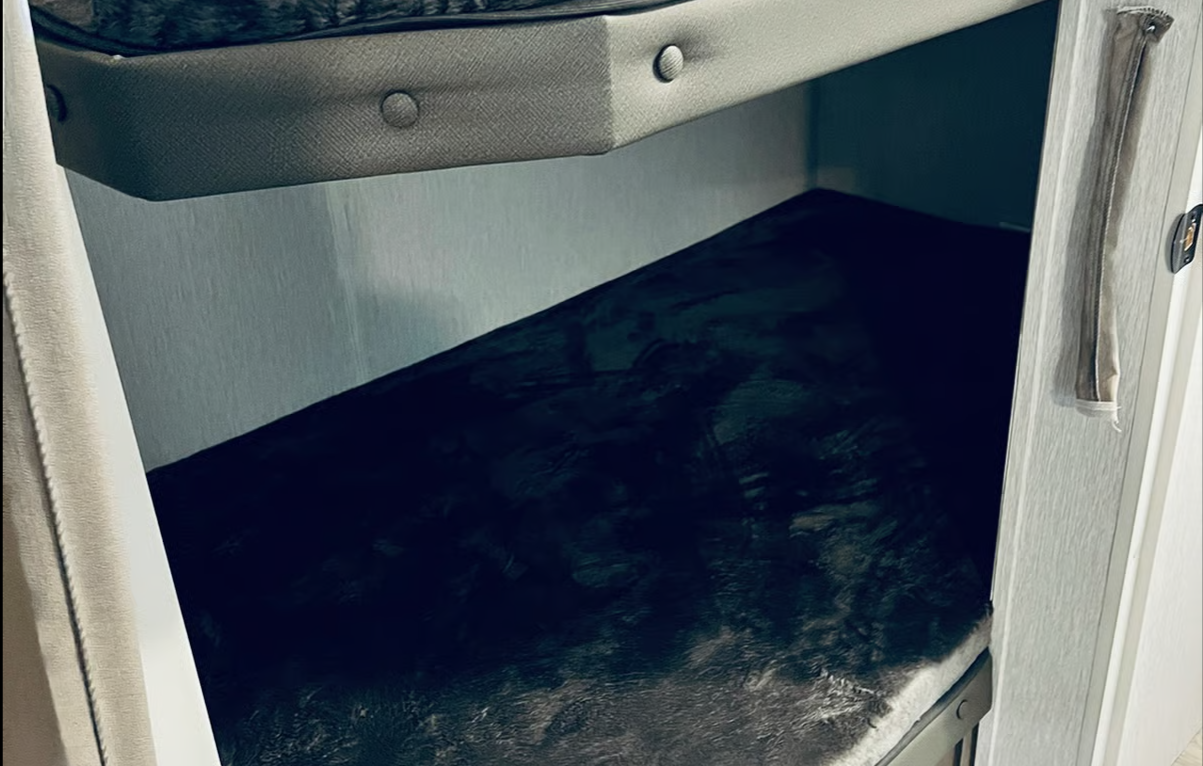 Double bunk beds equipped with a ladder for easy top entry.