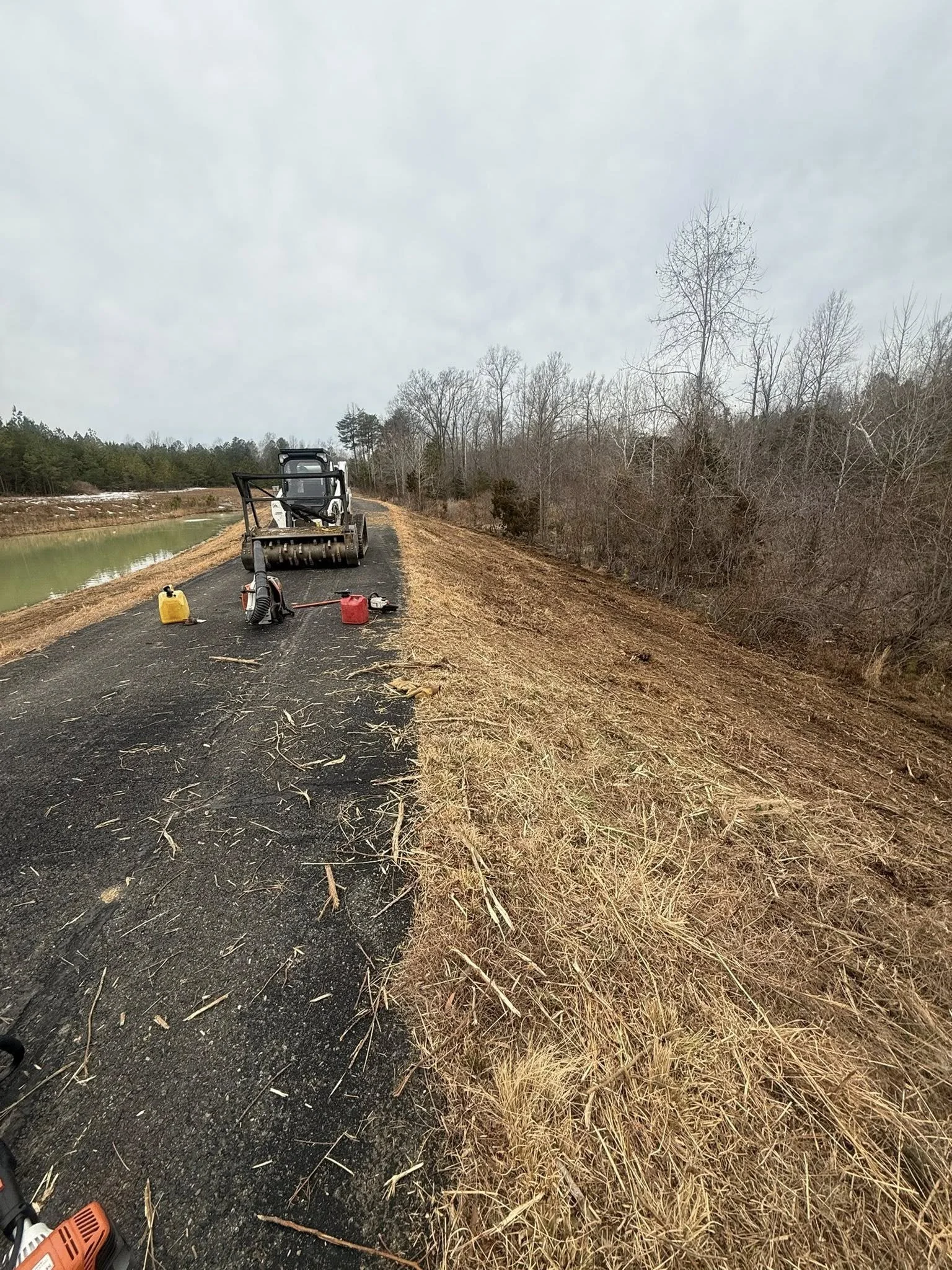 hillside clear from shrubbery after forestry attachment