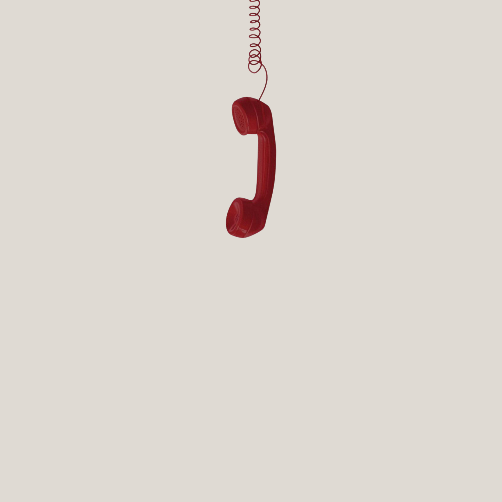 Red vintage telephone handset hanging from a coiled cord against a plain background.