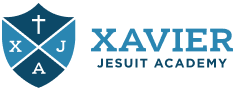 Xavier Jesuit Academy logo with a shield, cross, and initials XJA