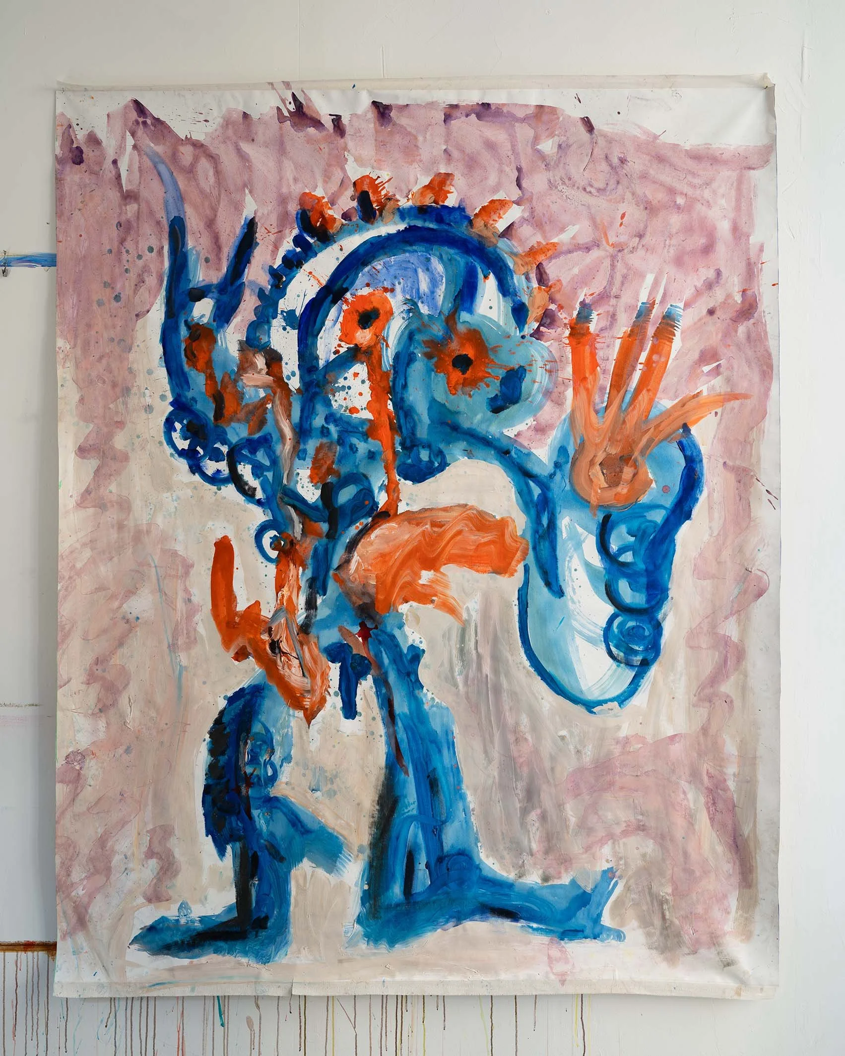 Abstract painting in blue and orange tones on a pinkish background, featuring a central figure with exaggerated hands and gestural brushstrokes.