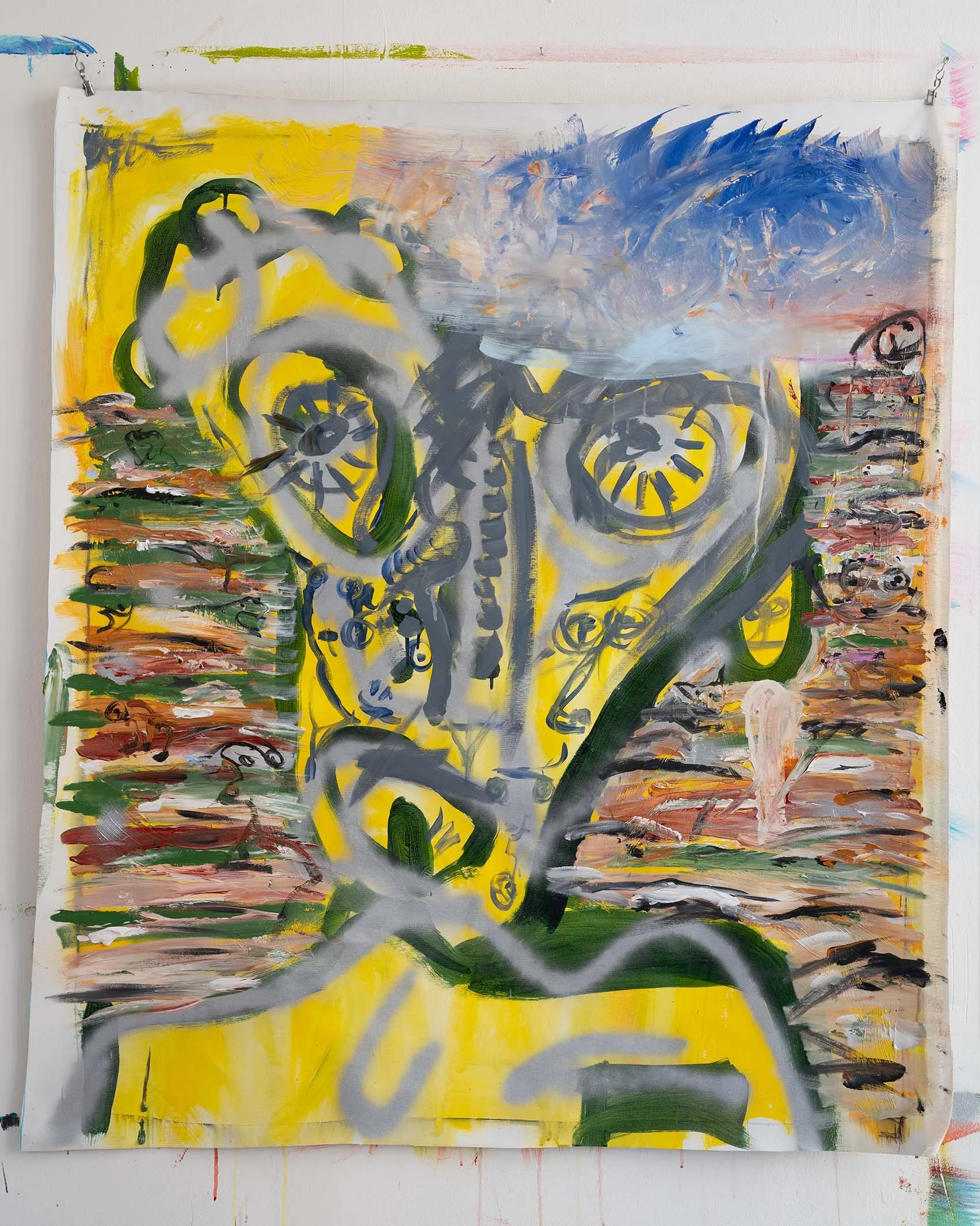 Abstract painting with vibrant colors, featuring a distorted face with large eyes, set against a yellow, blue, and multicolored background. The artwork includes bold brushstrokes and dynamic patterns.