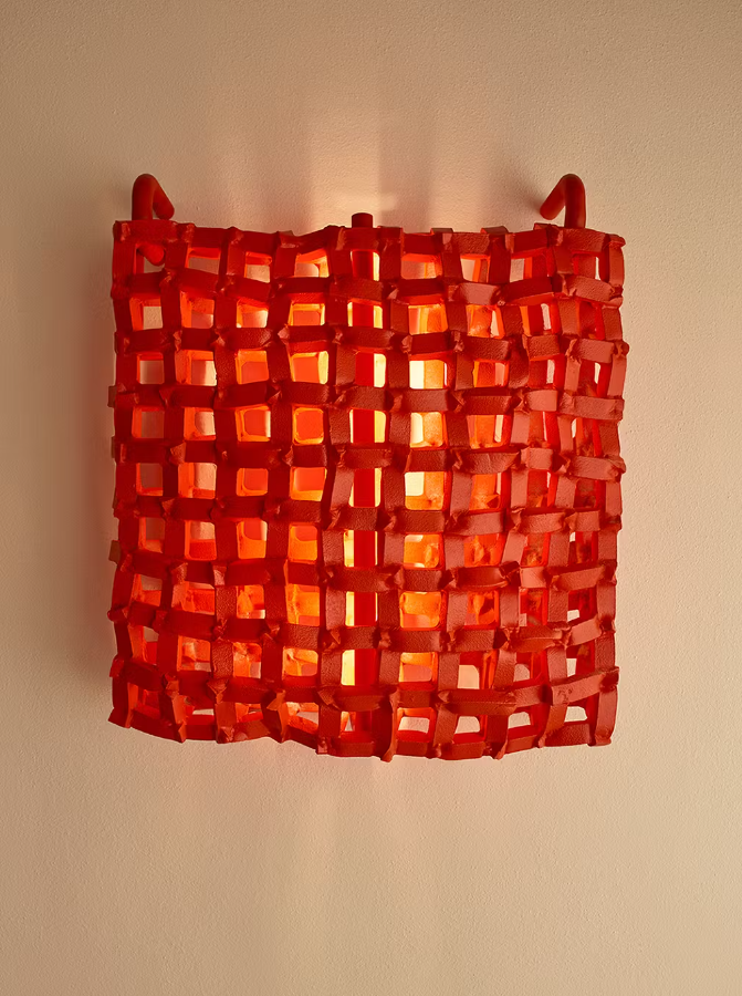 Red lattice wall sconce with warm light