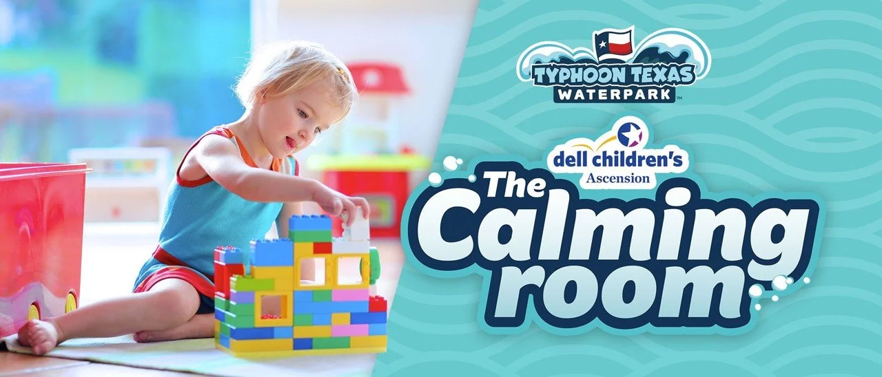 A young girl playing with colorful building blocks on a play mat in a bright, cheerful room.