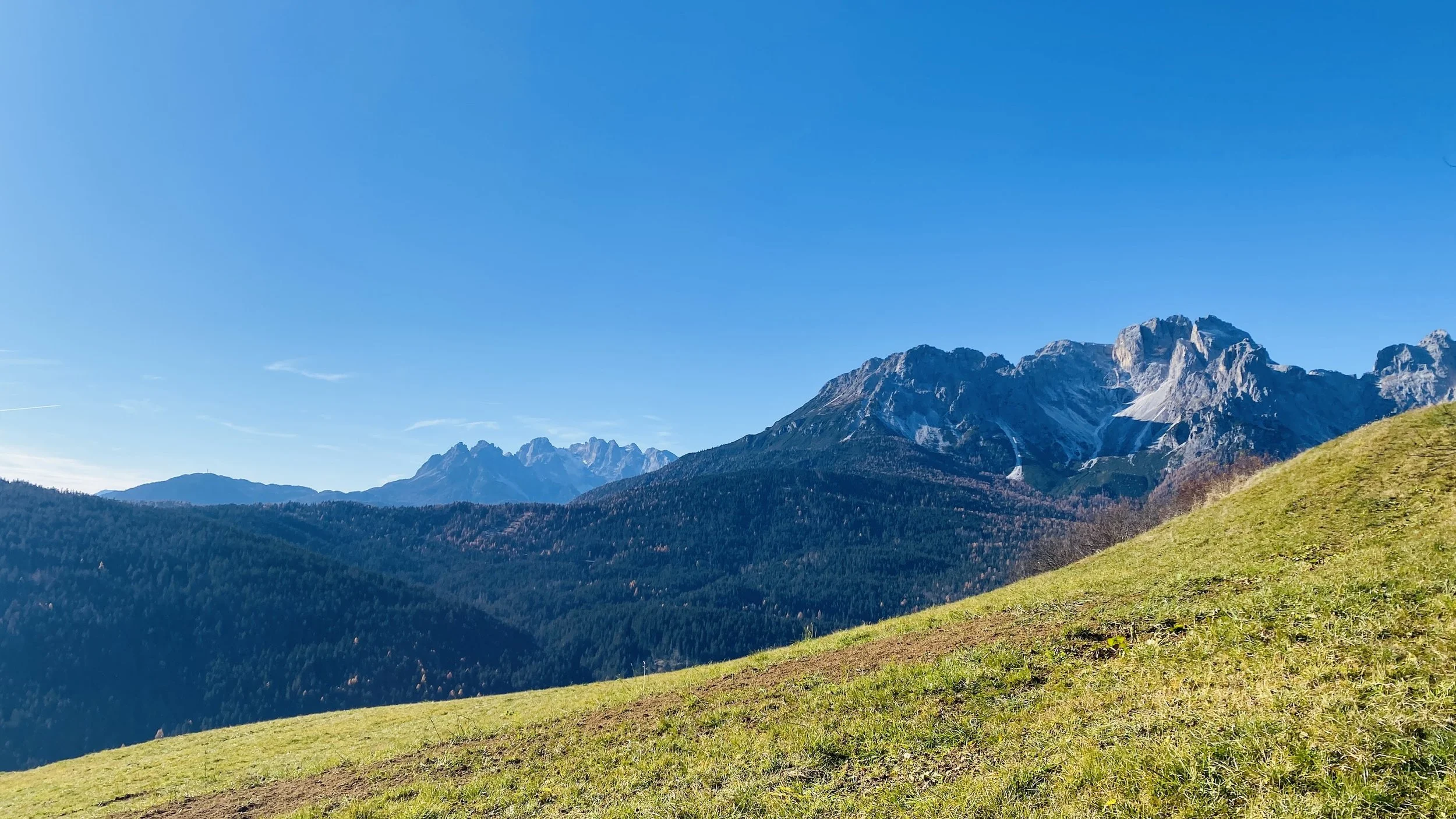 Paesaggio di montagne e colline verdi sotto un cielo blu