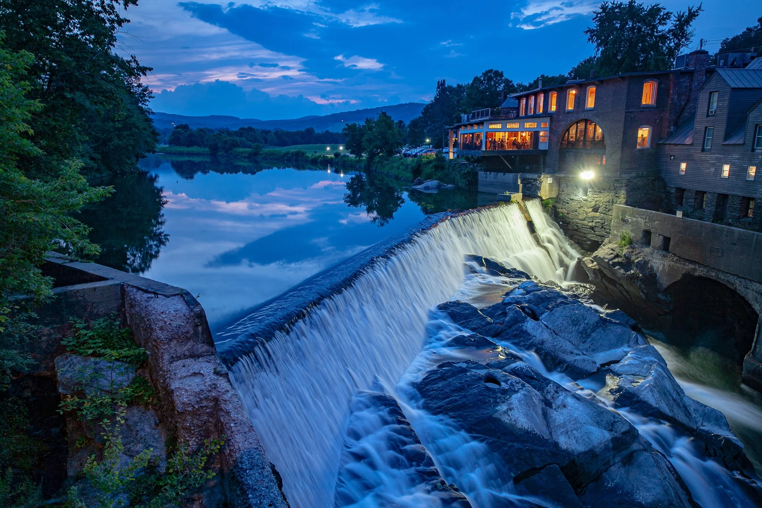 Image of the Ottauquechee River falls by Simon Pearce in Quechee VT at dusk
