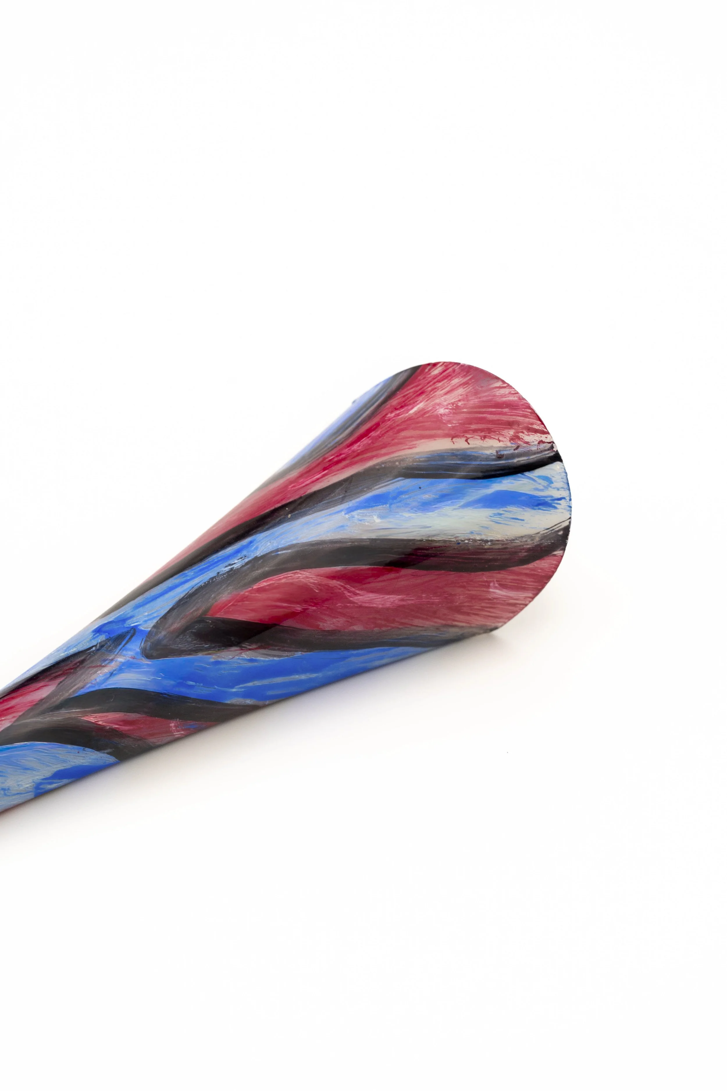 Lámina de vidrio pintada con rayas de colores rojo, azul, gris y negro, con forma curvada y superficie brillante.