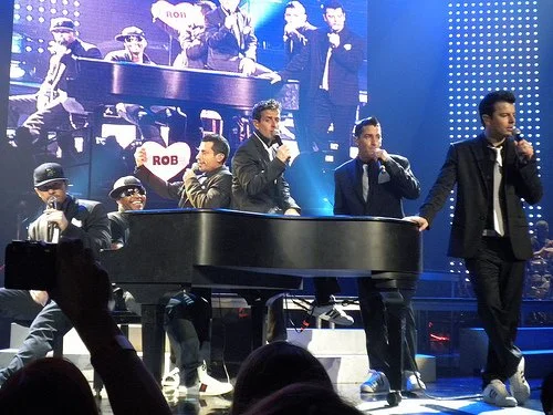 Rob Lewis on piano performing with New Kids On The Block during a live concert.