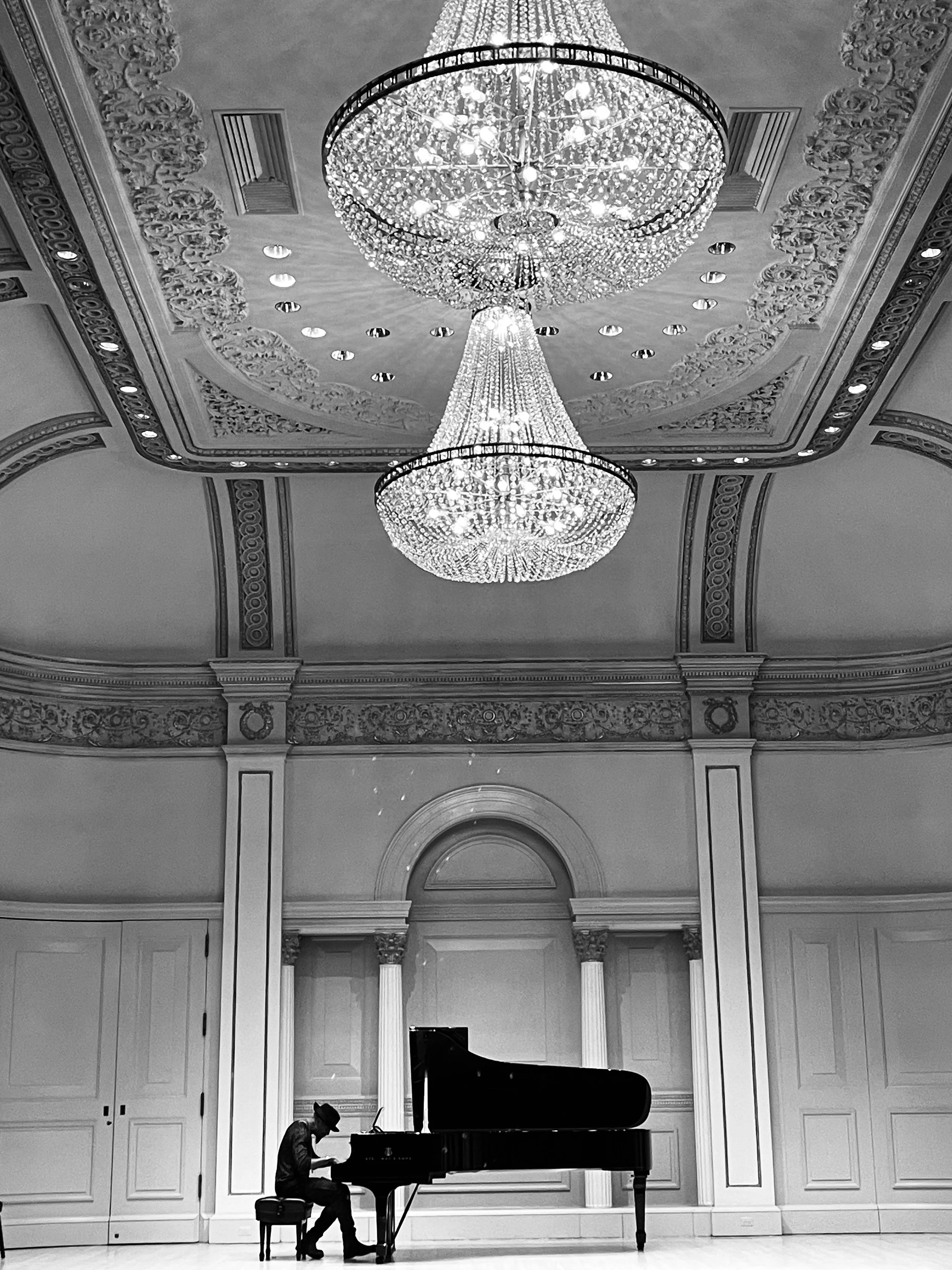 Rob Lewis seated at a grand piano in Carnegie Hall’s Weill Music Room.