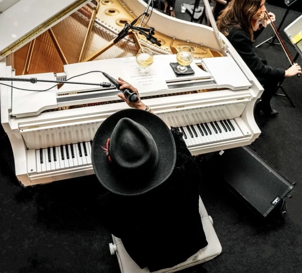Rob Lewis on piano at his "Rob Lewis and His Orchestra" performance, LA Magazine.