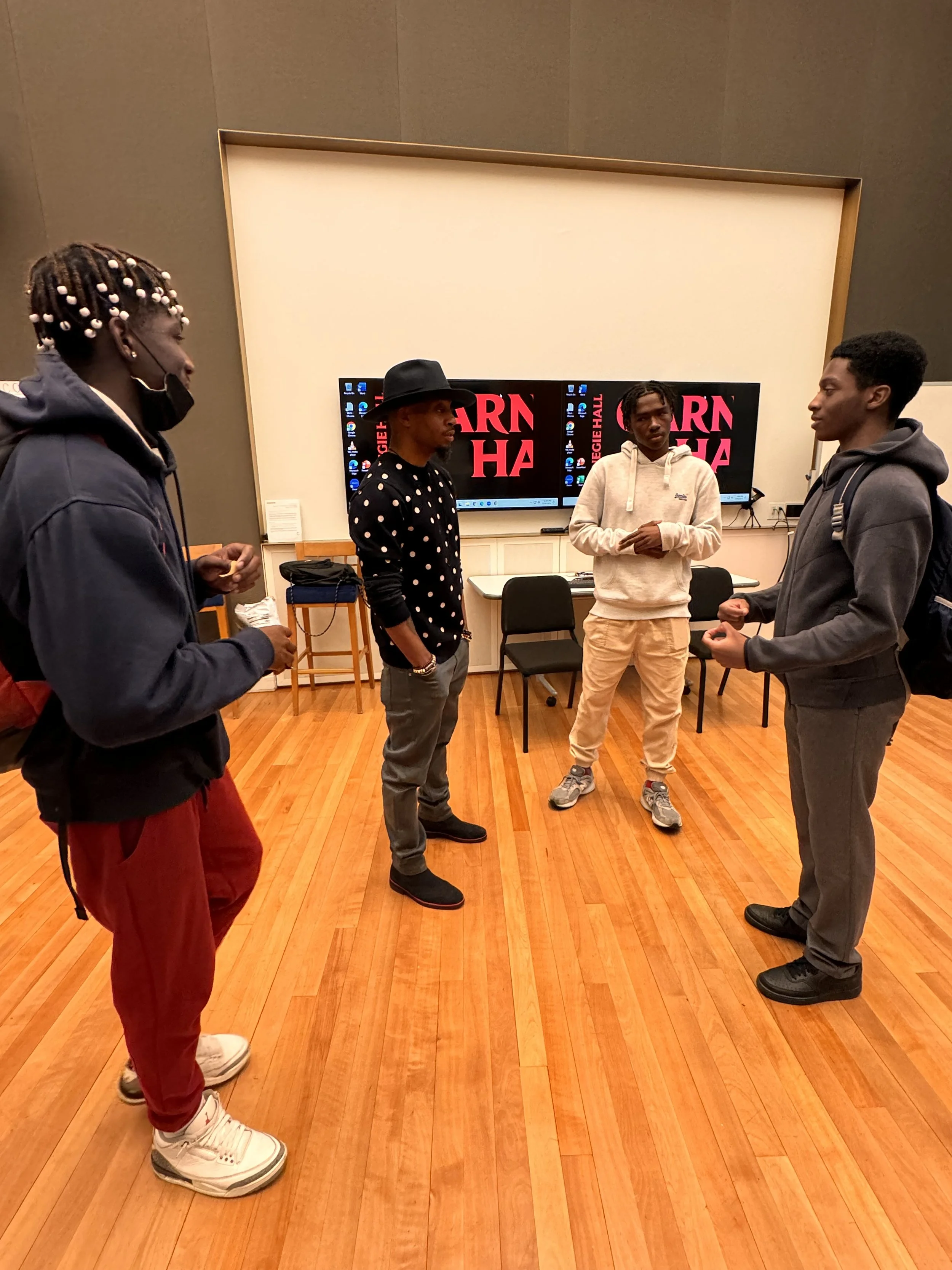 Rob Lewis conversing with students that are part of Carnegie Hall’s The B-Side program.