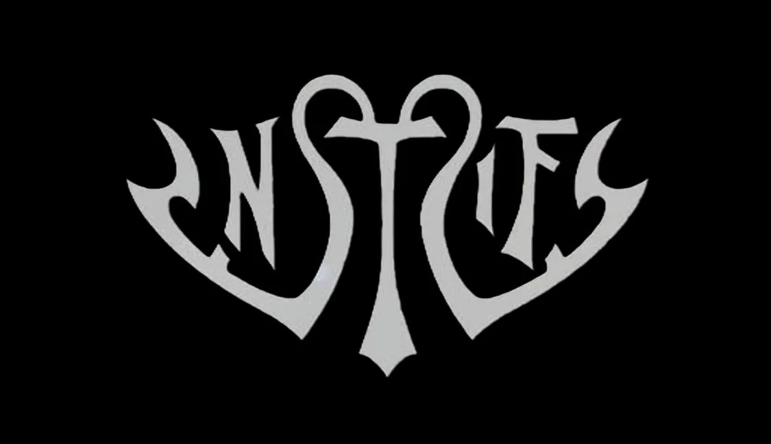 The word 'VINTAGE' stylized with heart shapes forming a cross and the letters, in vintage black and gray font on a black background.