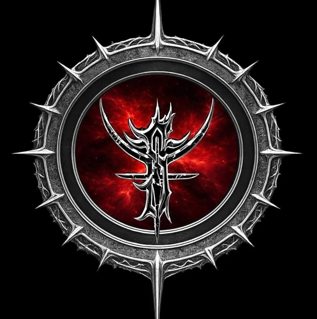 A dark circular emblem with a spiked silver border surrounding a red and black background. In the center, a stylized, metallic black and silver symbol with pointed, sharp edges.