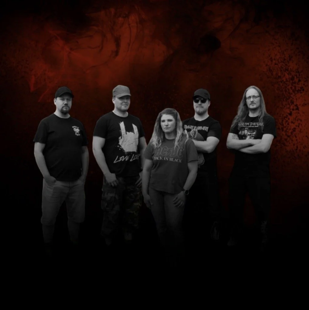 A black and white photo of five people standing in front of a dark, fiery red background.