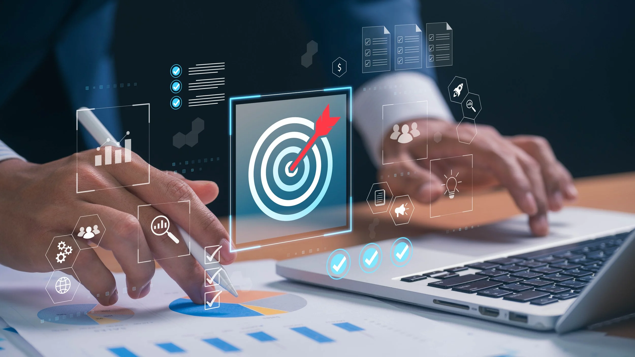 Hands working on a laptop with digital icons of target, charts, checkmarks, and business symbols overlayed.