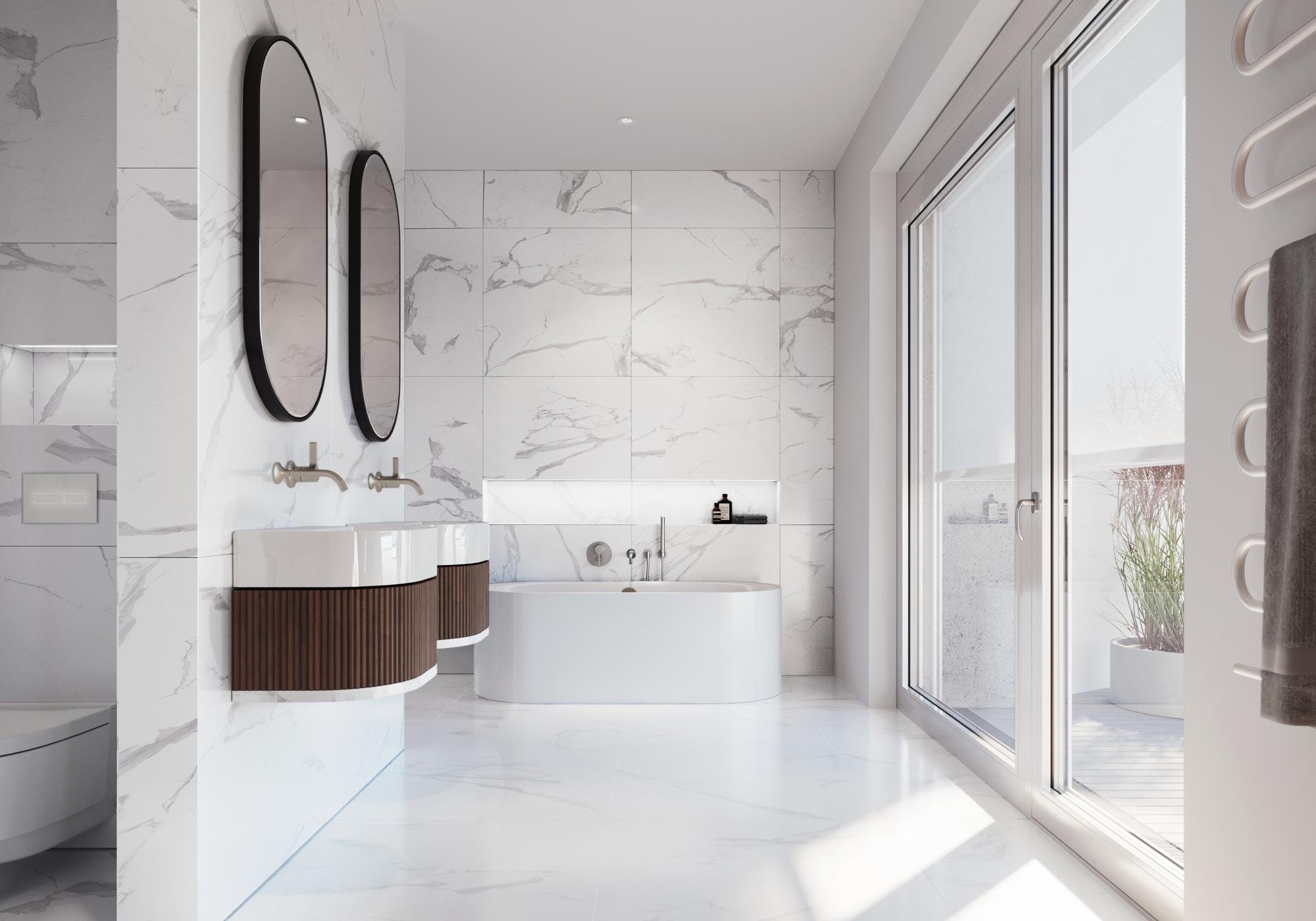 Ein modernes Badezimmer mit weißen Marmorelementen, zwei ovale Spiegel, einer Badewanne, einem Waschtisch, großen Fenstern und einem Heizkörper.