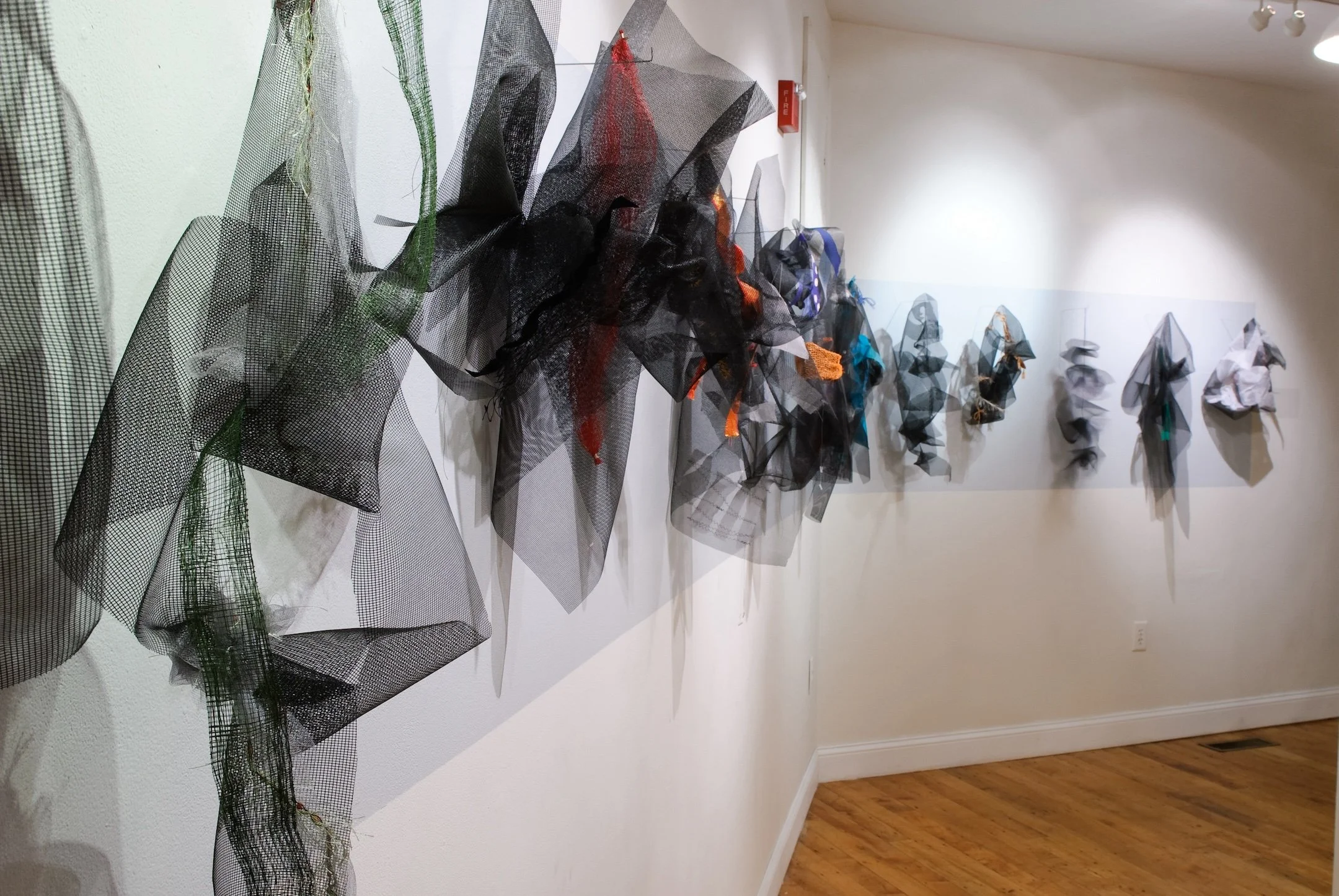 Bereft,  288"x30”x depths vary Cloth, fiberglass screening, thread, beads