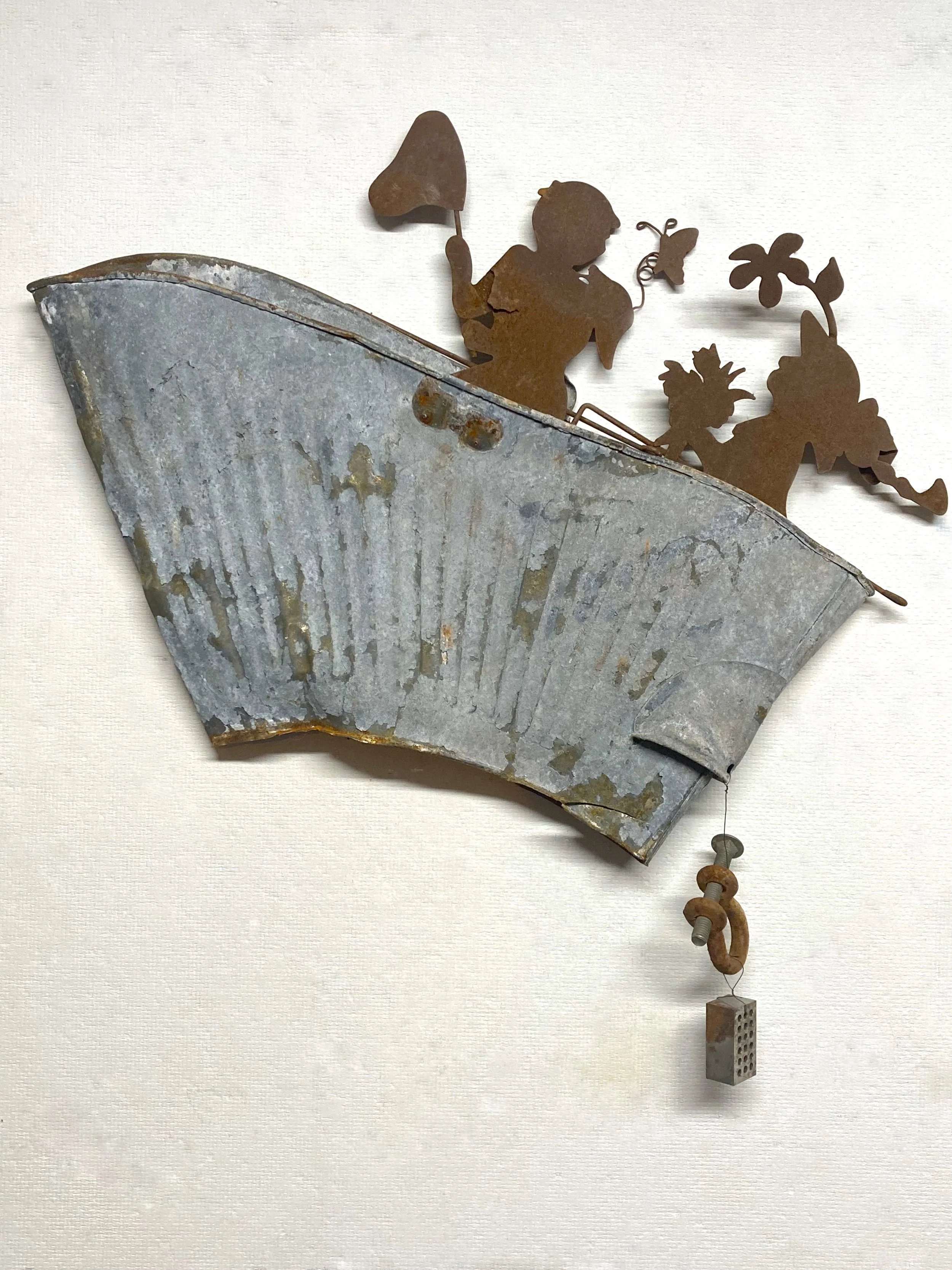 Jack and Jill,  23"x23"x3.5” Found metal: pail, old lawn ornaments, nuts and bolts