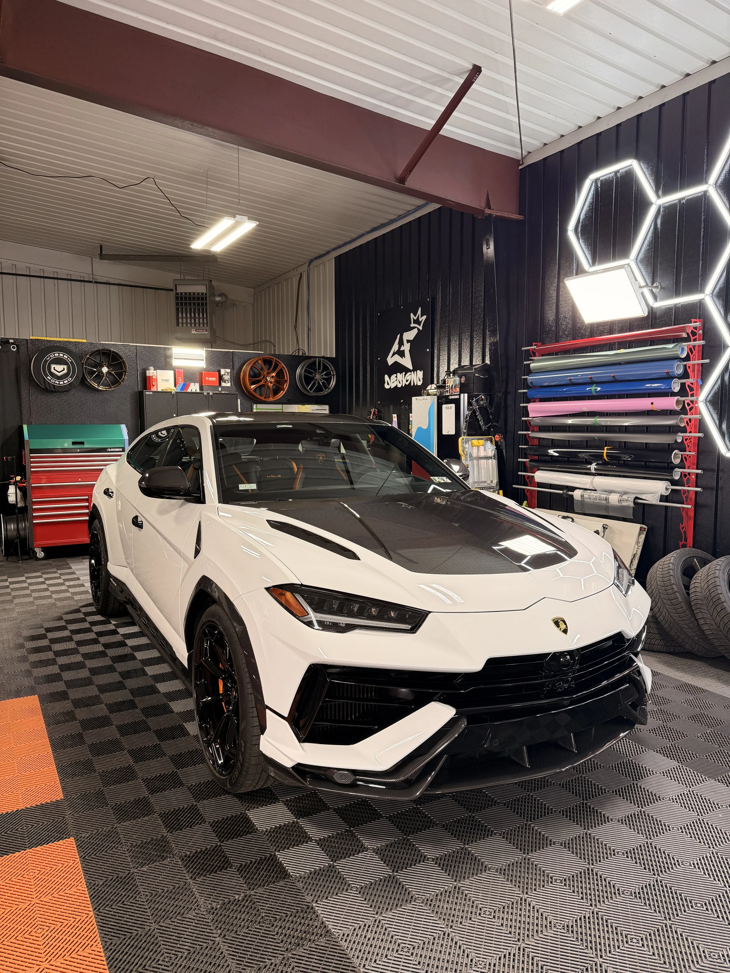 White Lamborghini Urus Performante in the shop after receiving a full Paint Correction, Clear Paint protection film to protect against all road debris, rock chips, scratches and Environmental damages. Then Ceramic Coated and sent out! CMG Auto Lab