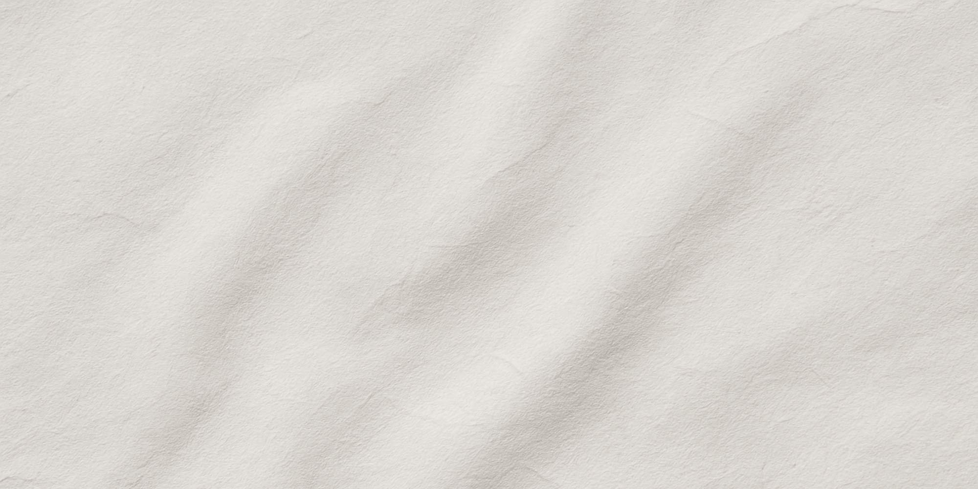 Close-up of a textured light-colored paper surface.