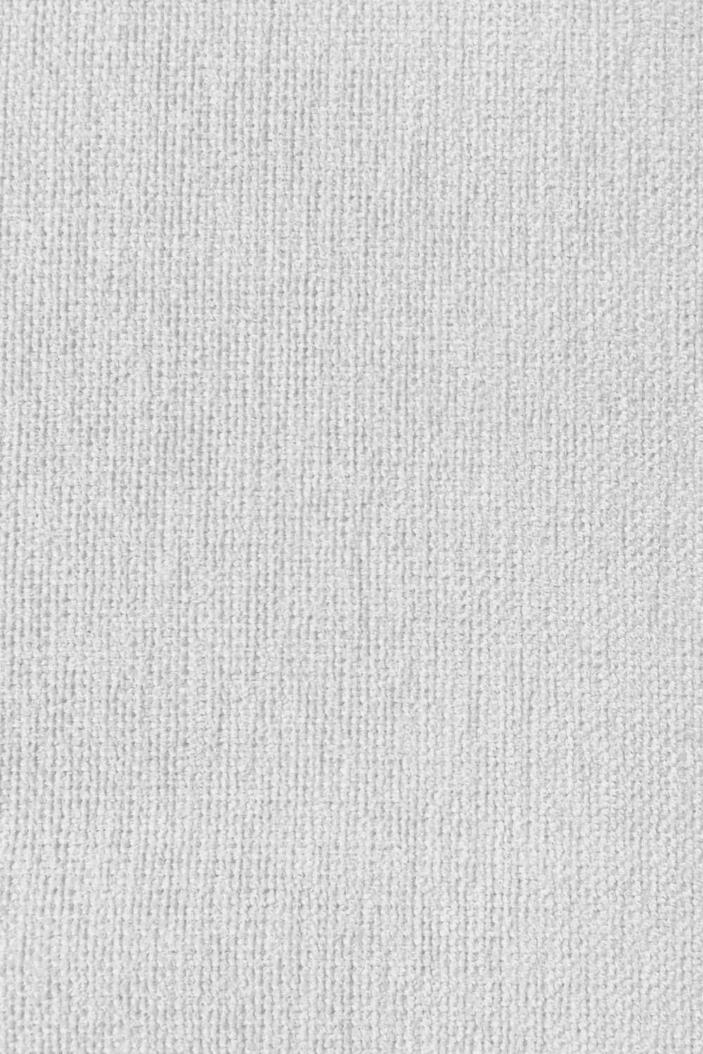 Close-up view of a textured white fabric surface.