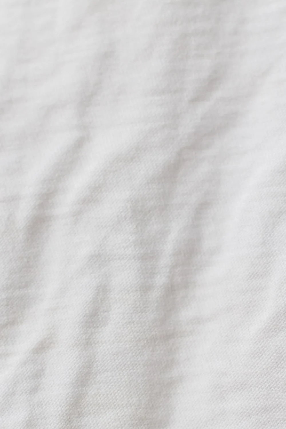 Close-up image of white fabric with a smooth texture.