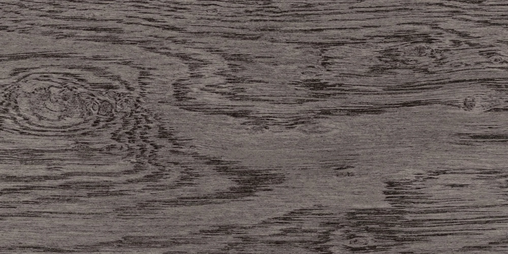 Close-up of a wooden surface with visible wood grain and knots.