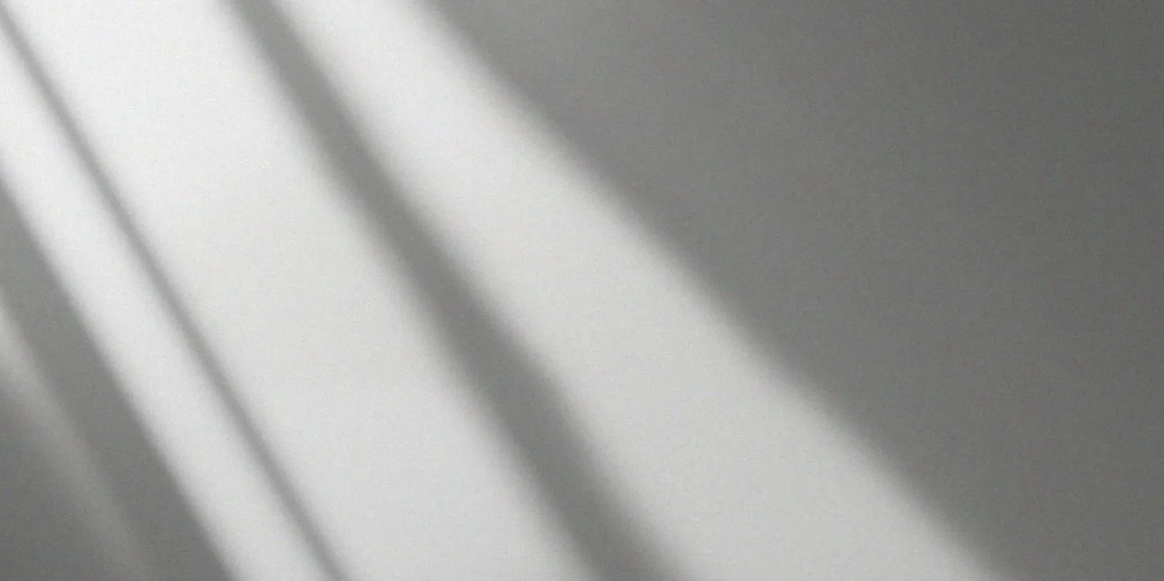 Shadow lines cast on a light-colored wall.