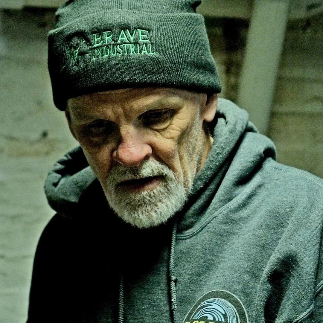 Plumber evaluating deep drain blockage in basement plumbing area.