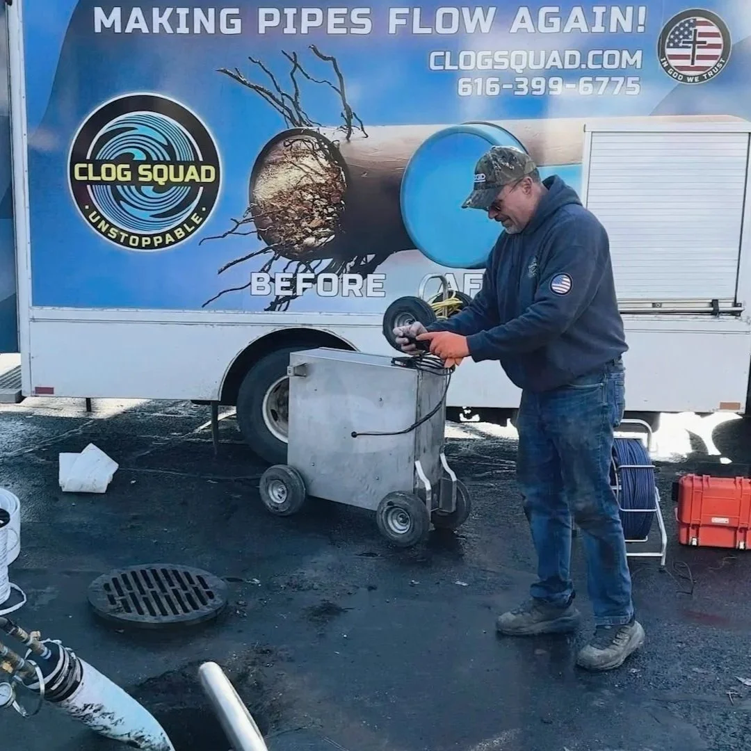 Plumber using sewer camera to inspect underground drain line.