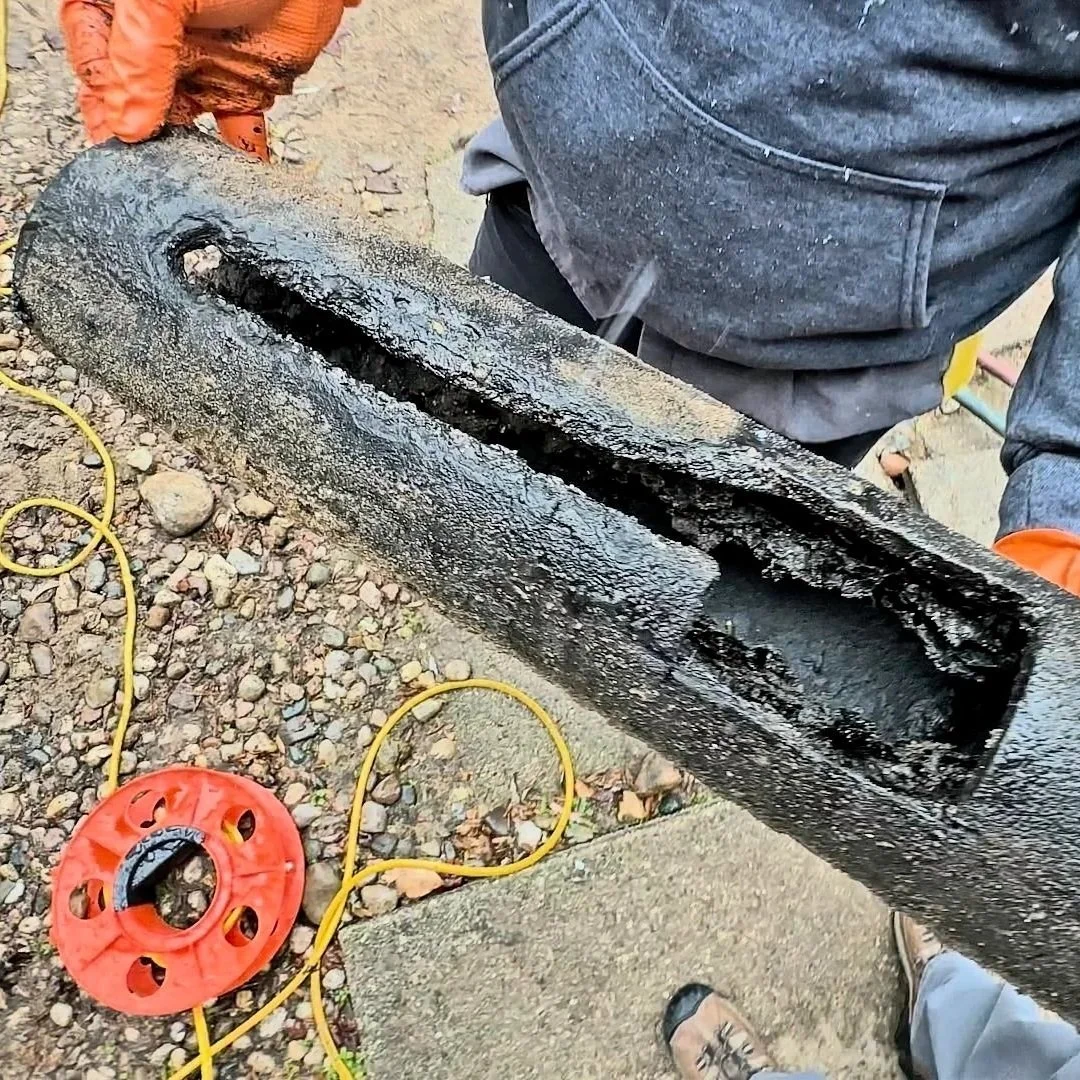 Corroded sewer pipe removed to assess damage before trenchless repair.