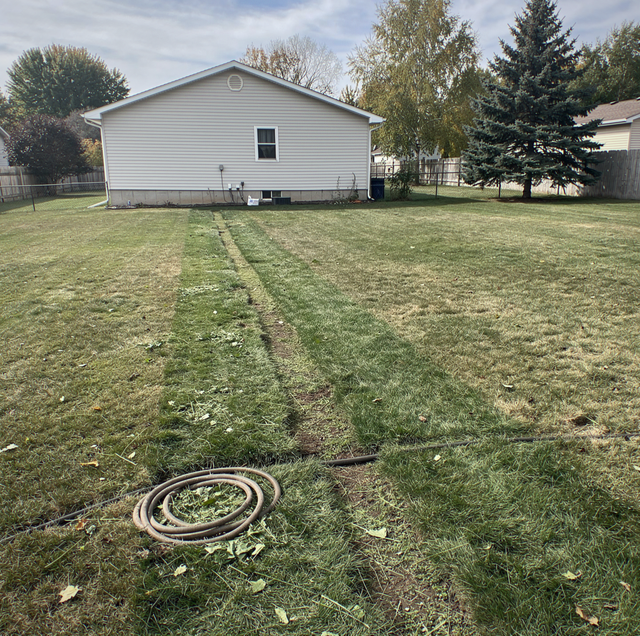 sunken lawn strip above leaking underground sewer pipe