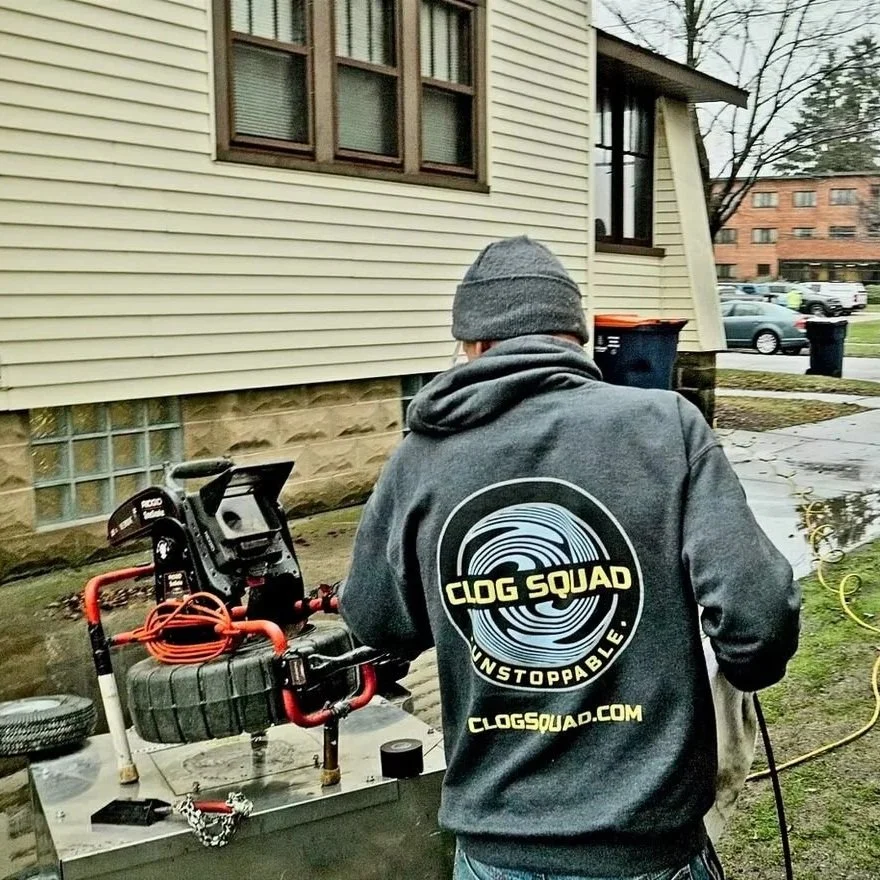 Plumbing technicians assessing a toilet drainage problem outside a home, illustrating professional diagnosis after plunging fails, including drain inspections, auger use, sewer line troubleshooting, and blockage detection.