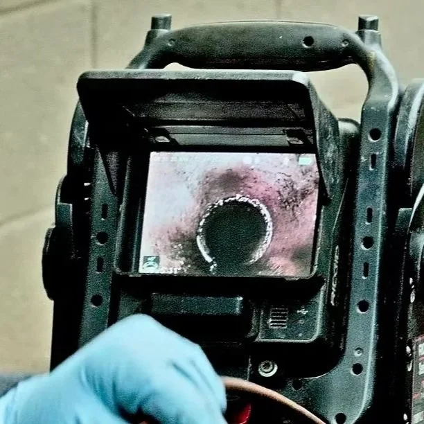 Monitor displays live sewer camera inspection footage inside a residential drain pipe, helping plumbers identify roots, blockages, cracks, scale buildup, and other underground sewer line defects accurately.