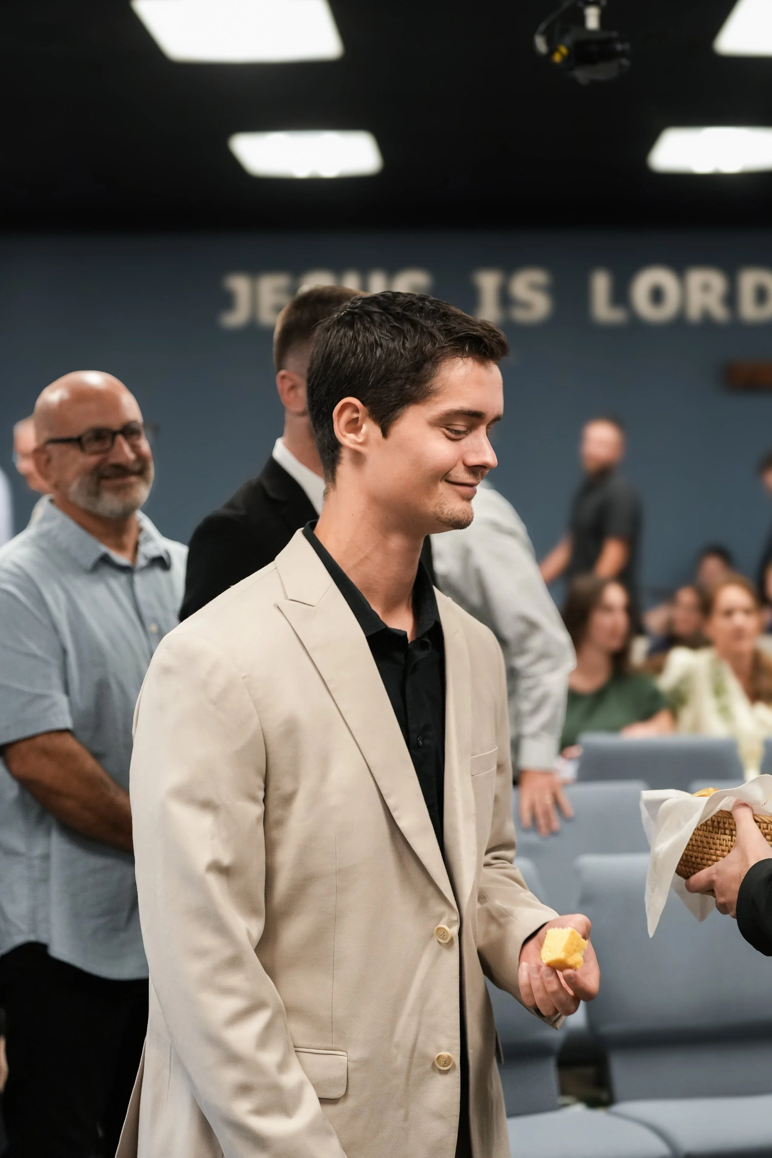 Man receiving bread from the Lord's Table
