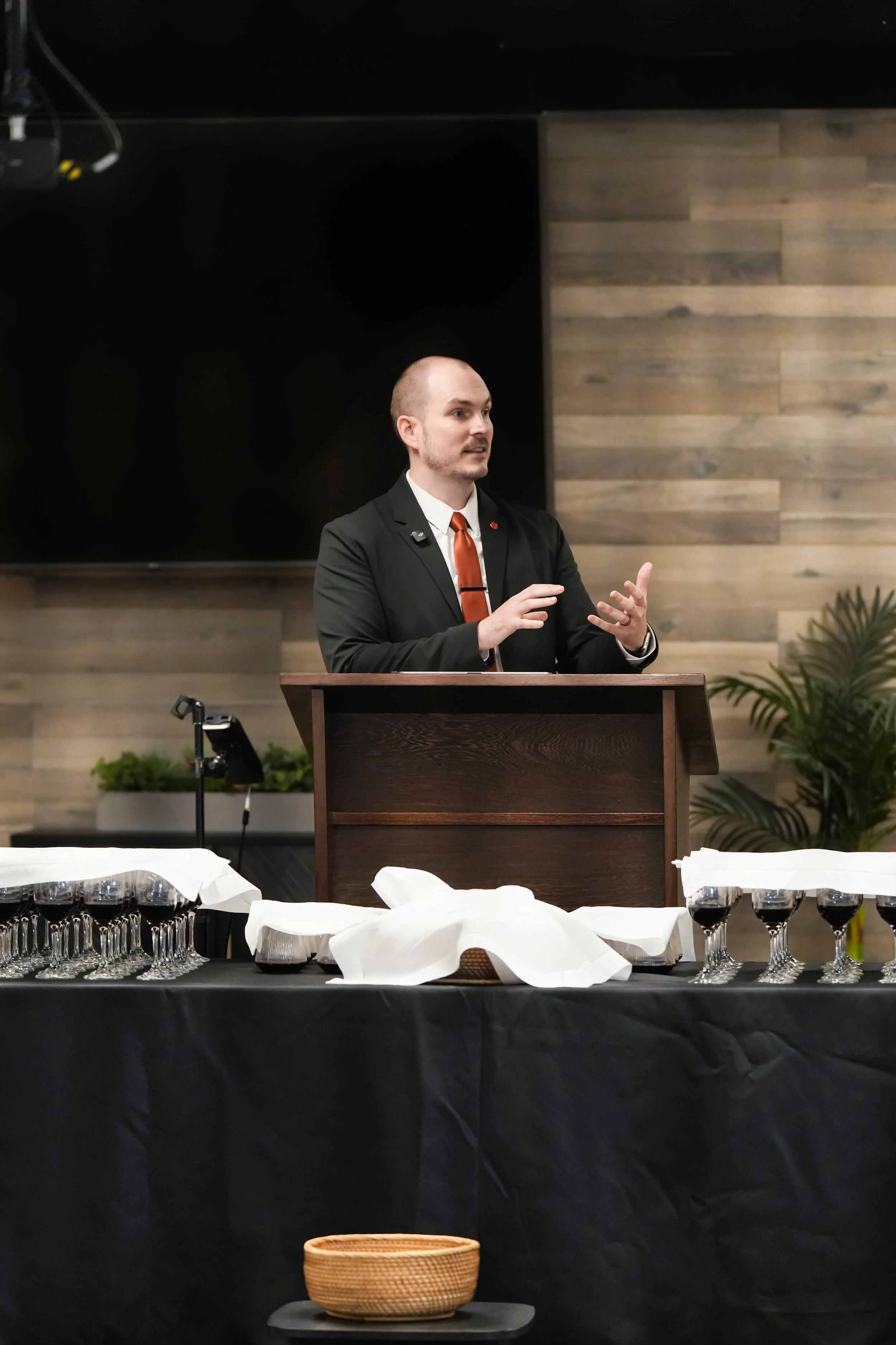 Pastor preaching before the Lord's Table