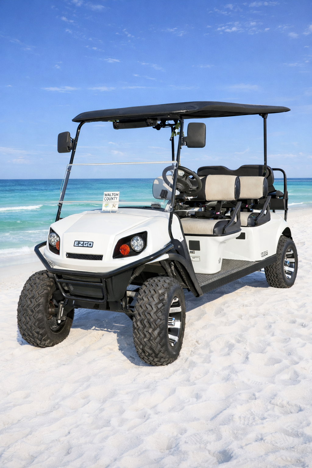 White rental golf cart from Emerald Coast Beach Rides & Rentals pictured at Miramar Beach