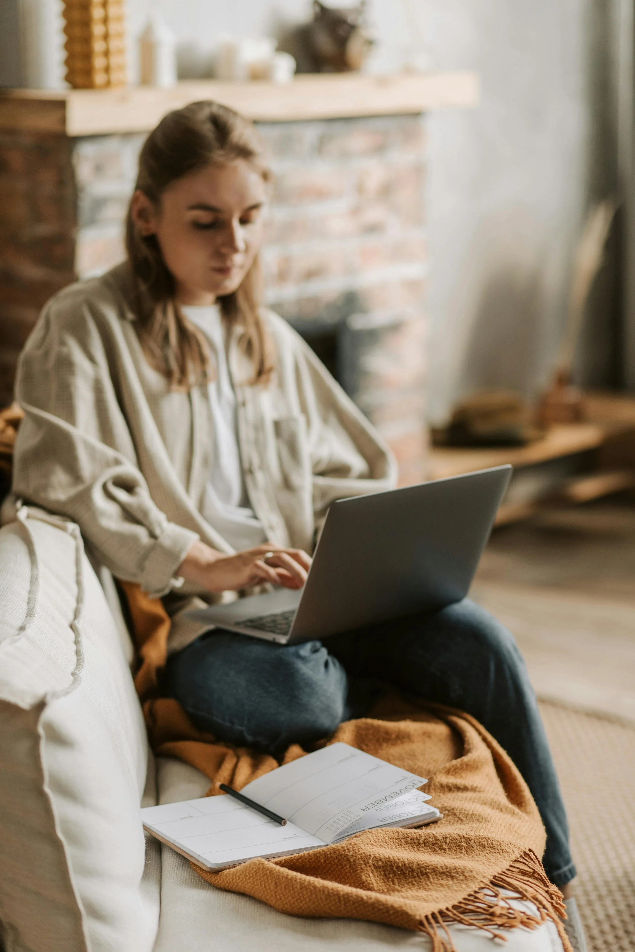 Student sitting on couch working on laptop