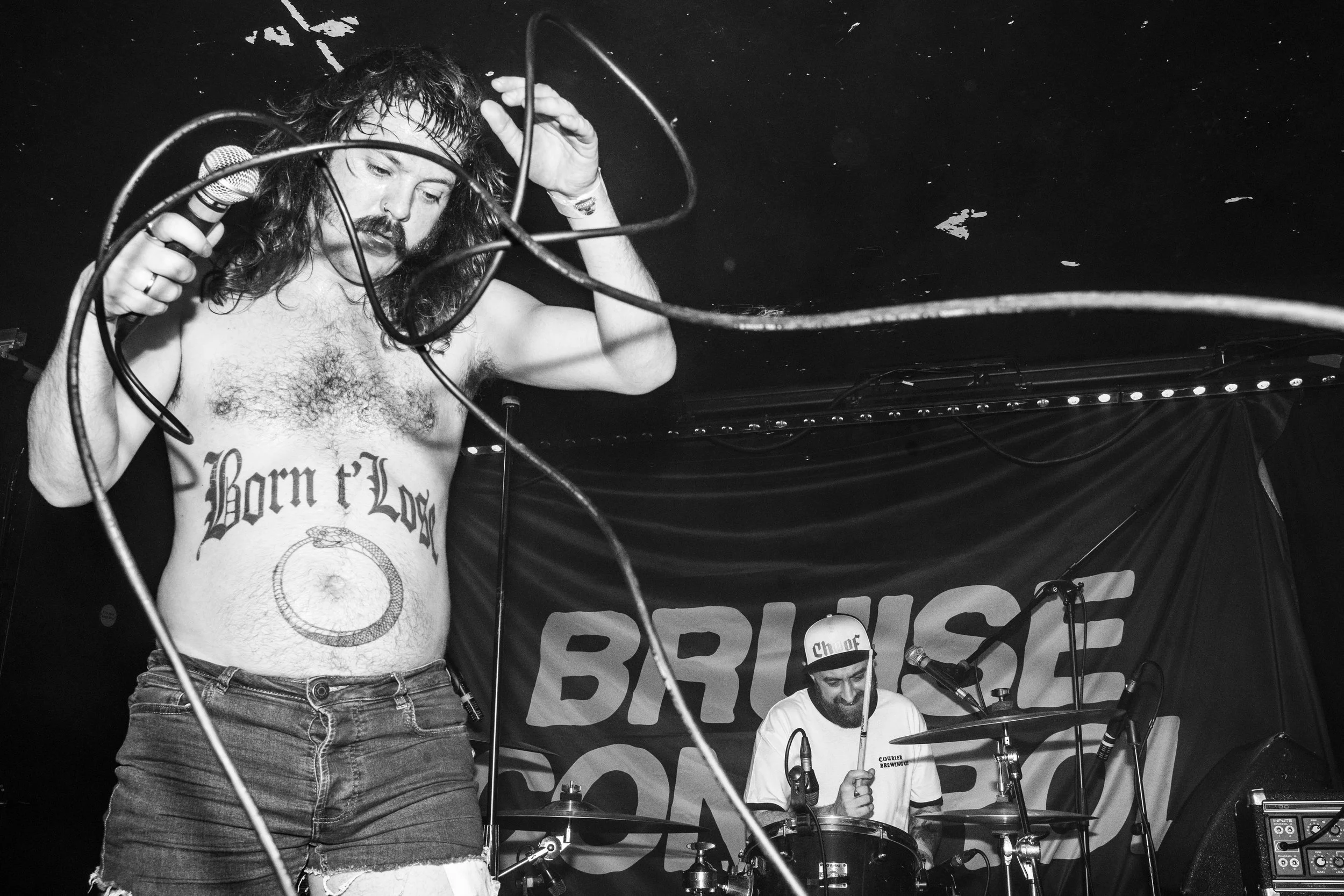 Punk band, Bruise Control, wearing Courier Brewing merch at a gig in Manchester, UK