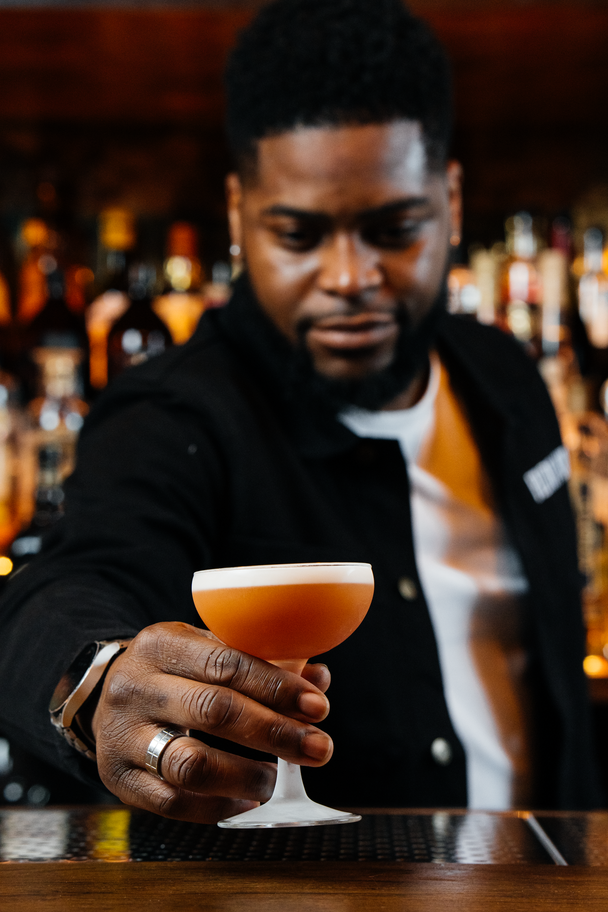 Bartender presenting a red cocktail at Filthy XIII, Bristol