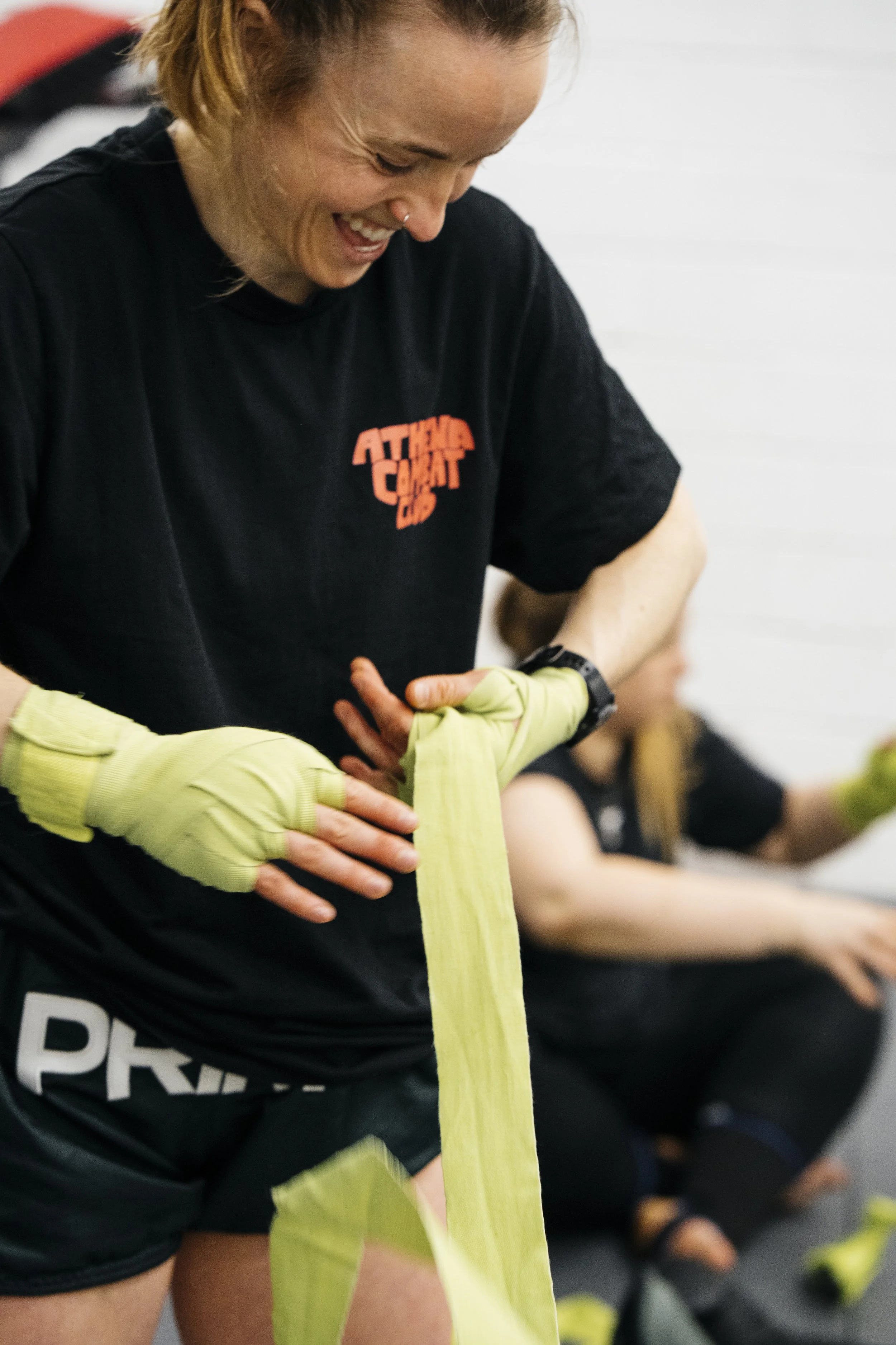 Ash Guest, UK No.8 women's Muay Thai fighter, wrapping her hands at Athena Combat Club Fighter's Class