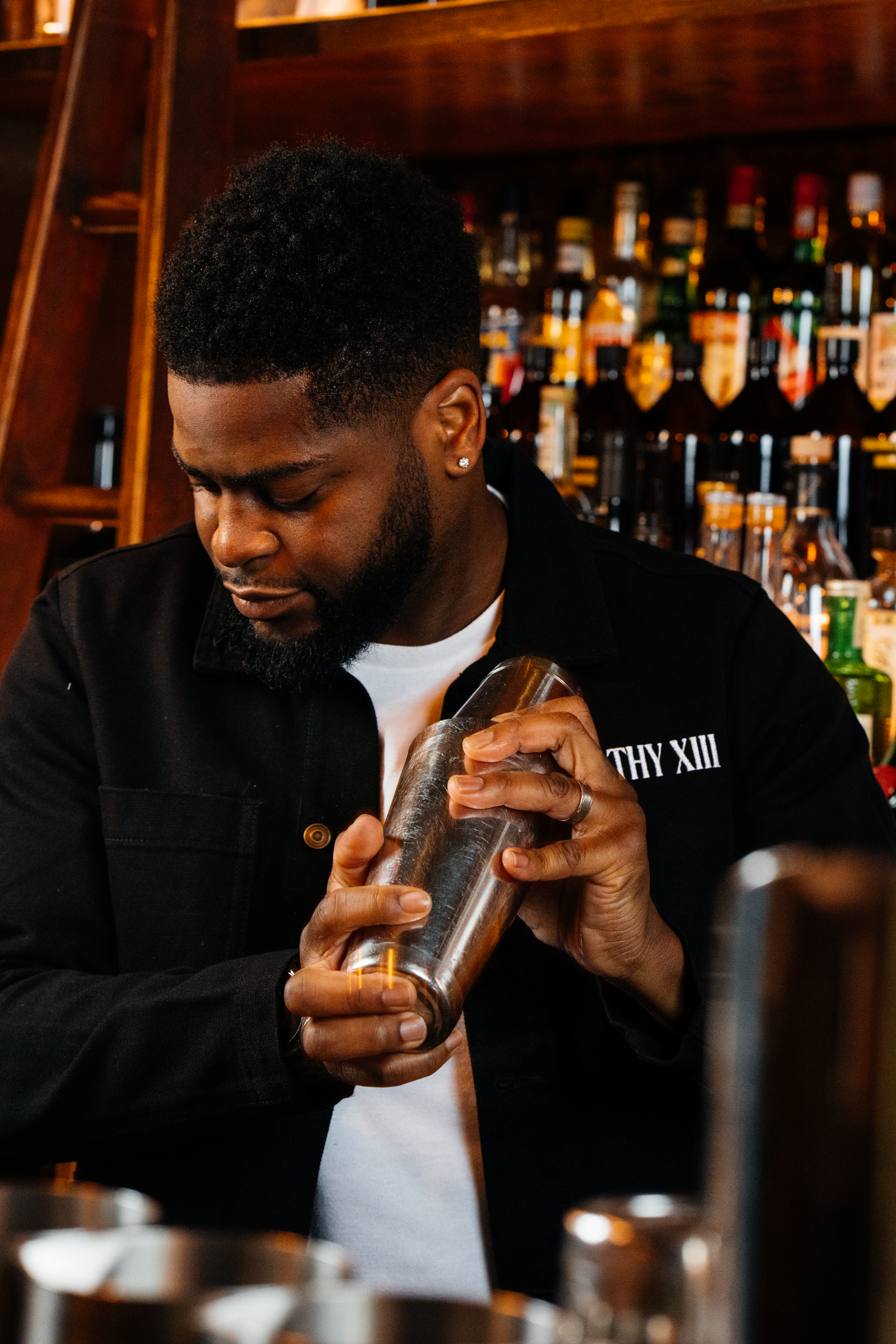 Bar tender shaking a cocktail at Filthy XIII, Bristol