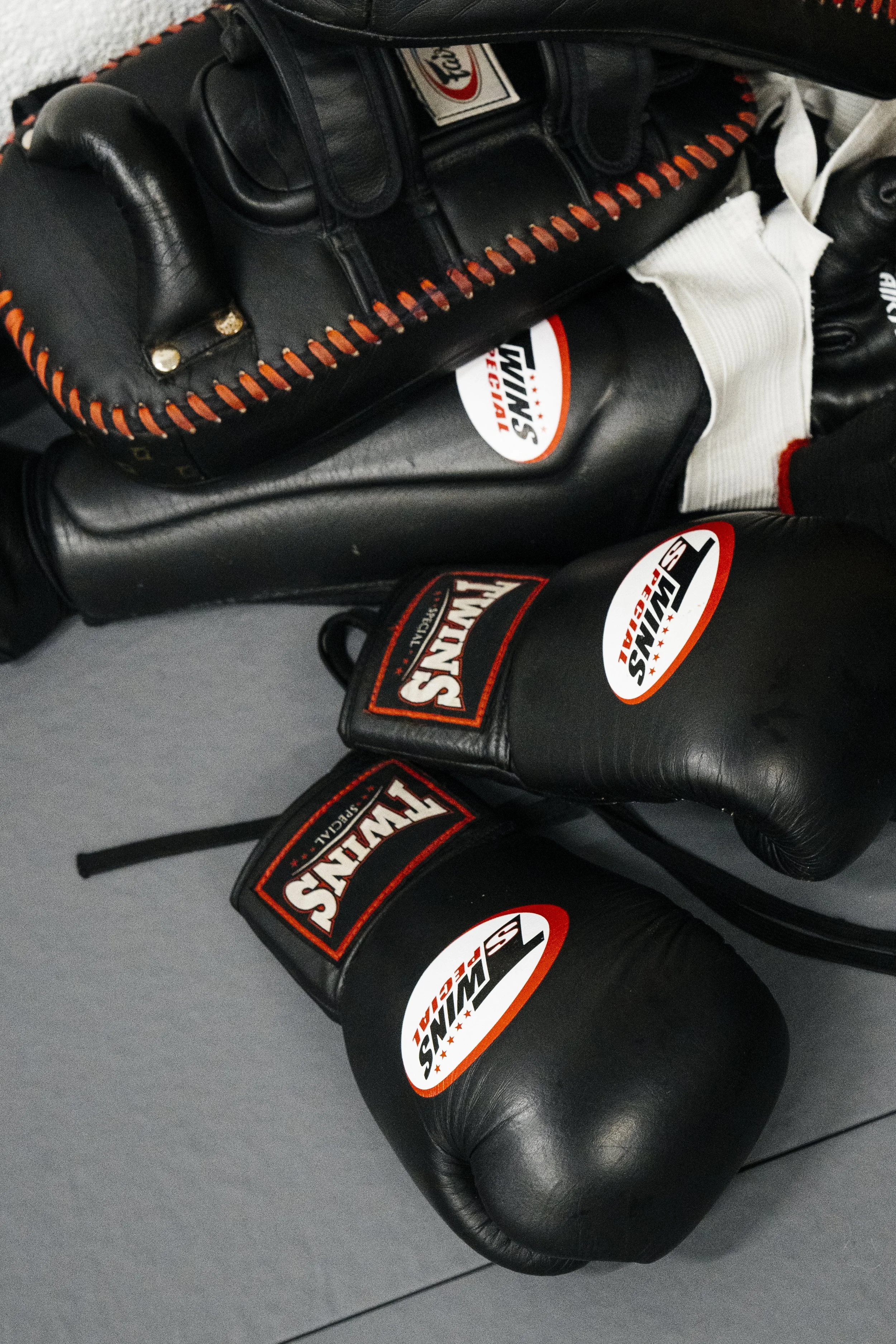 Kickboxing gloves and pads on the floor at Athena Combat Club Fighter's Class at Cool Heart Muay Thai Studios, Bristol